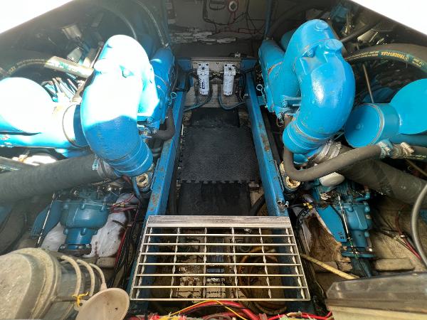 Engine room of a 1985 Viking 35 Express with blue engines.