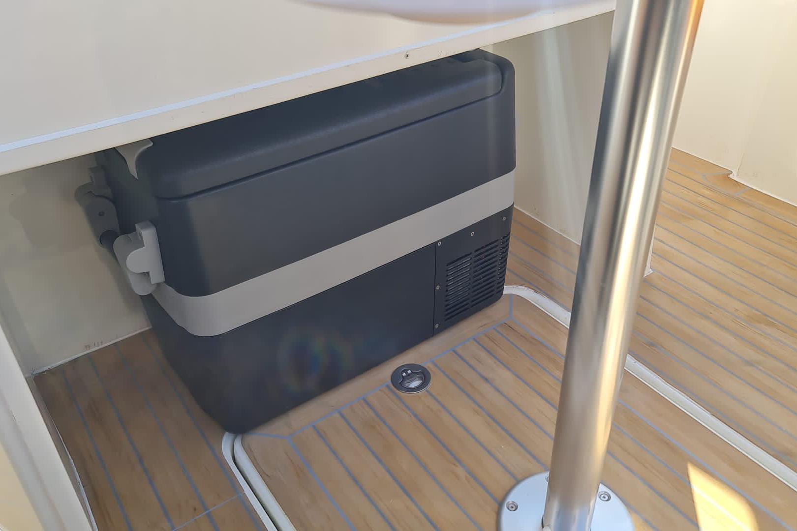 Storage compartment on 2025 NUVA YACHTS M6 Fisher with wooden flooring.