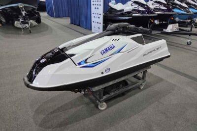 2026 Yamaha WaveRunner SuperJet displayed indoors on a stand.