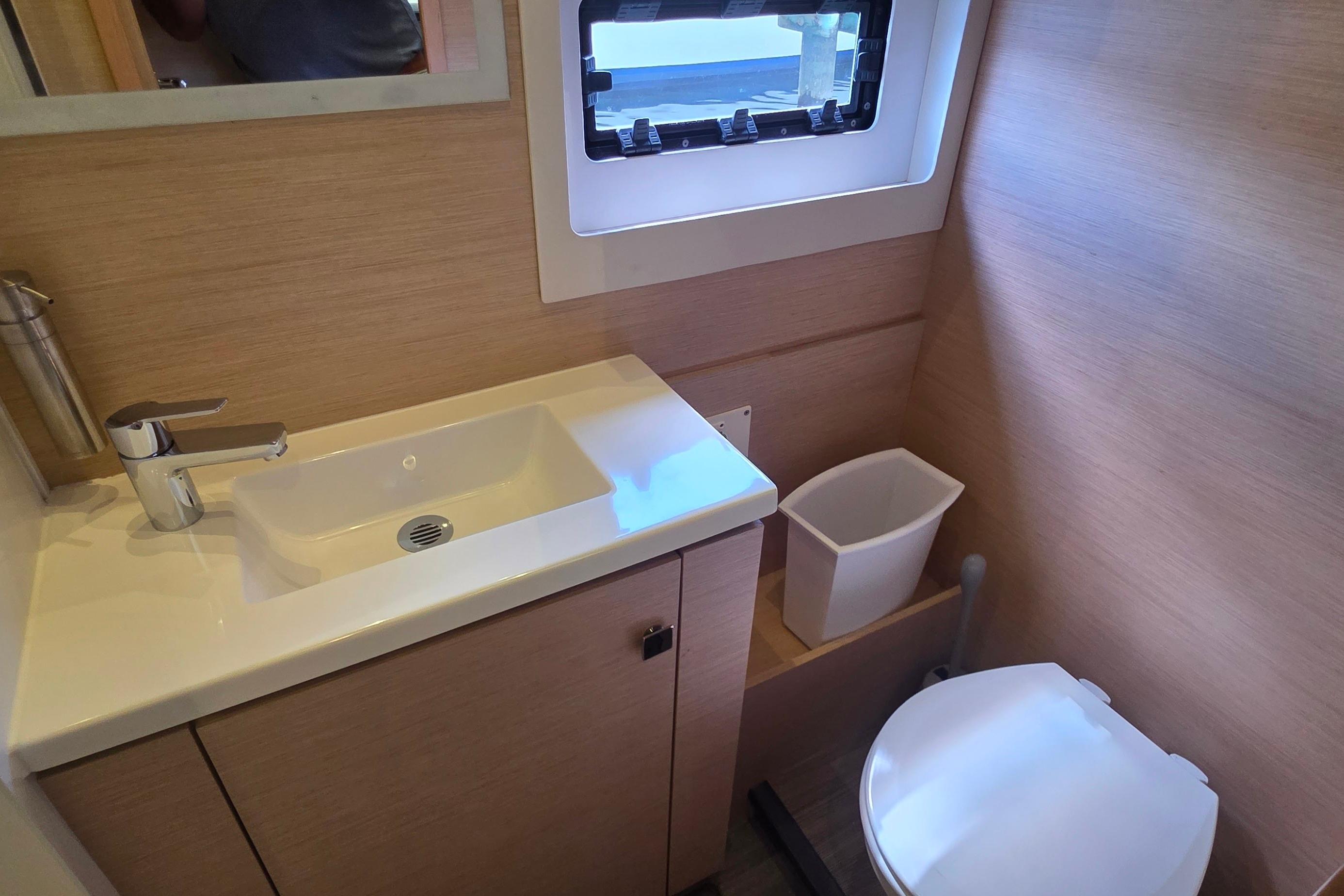 Bathroom interior of 2018 Fountaine Pajot Motor Yacht 44, featuring sink and toilet.