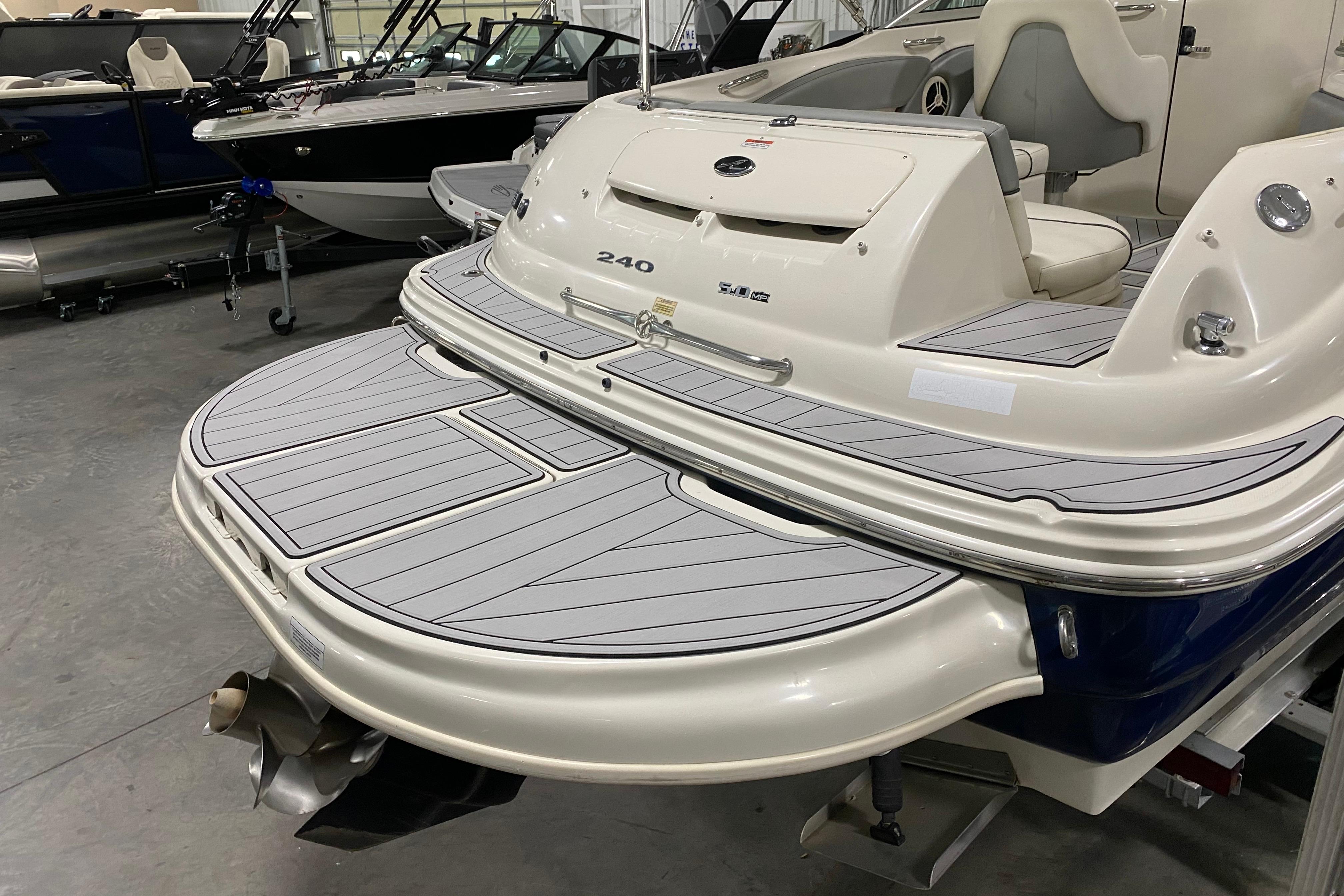 2008 Sea Ray 240 Sundeck boat with swim platform in showroom.