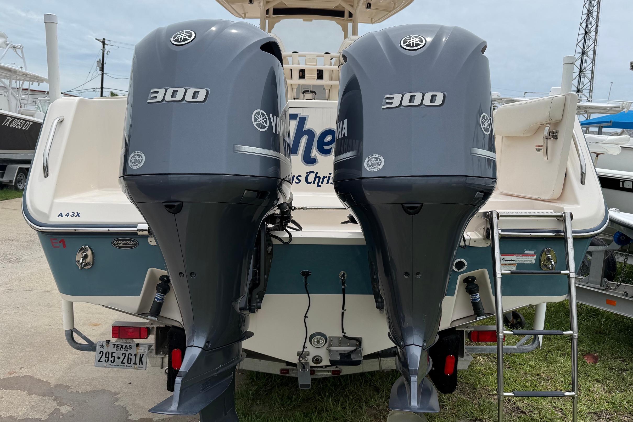 2018 Grady-White Canyon 306 boat with twin Yamaha 300 engines, docked outdoors.