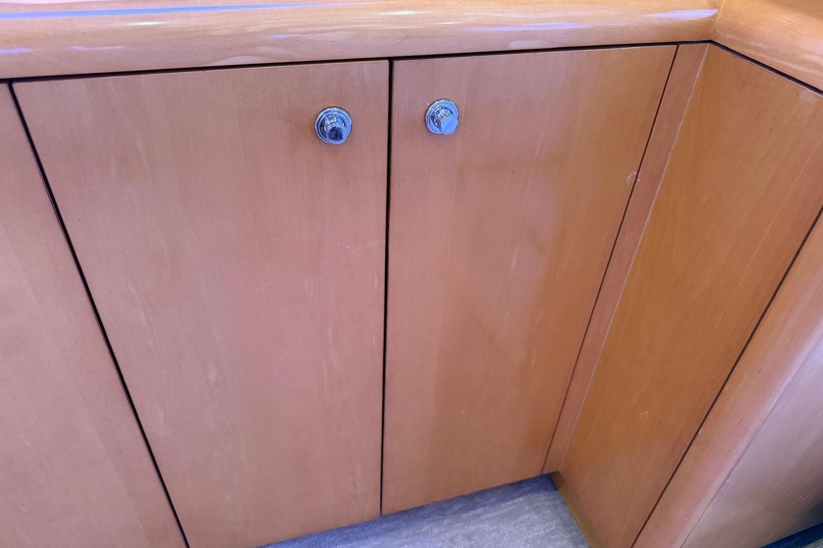 Wooden cabinet doors on a 2003 Hatteras 54 Convertible yacht interior.