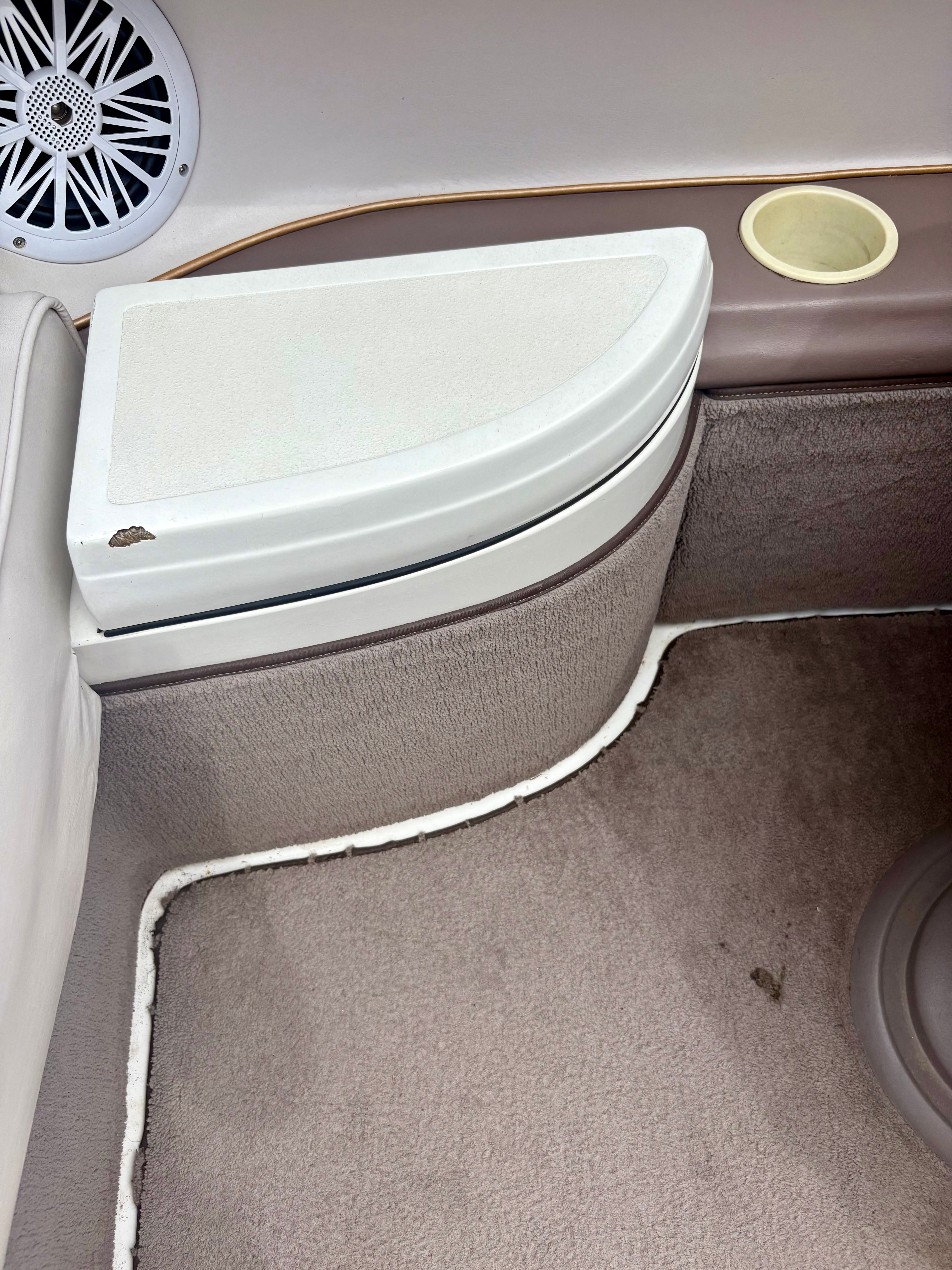 Interior of a 1995 Cobalt 252 boat with speaker and cup holder.