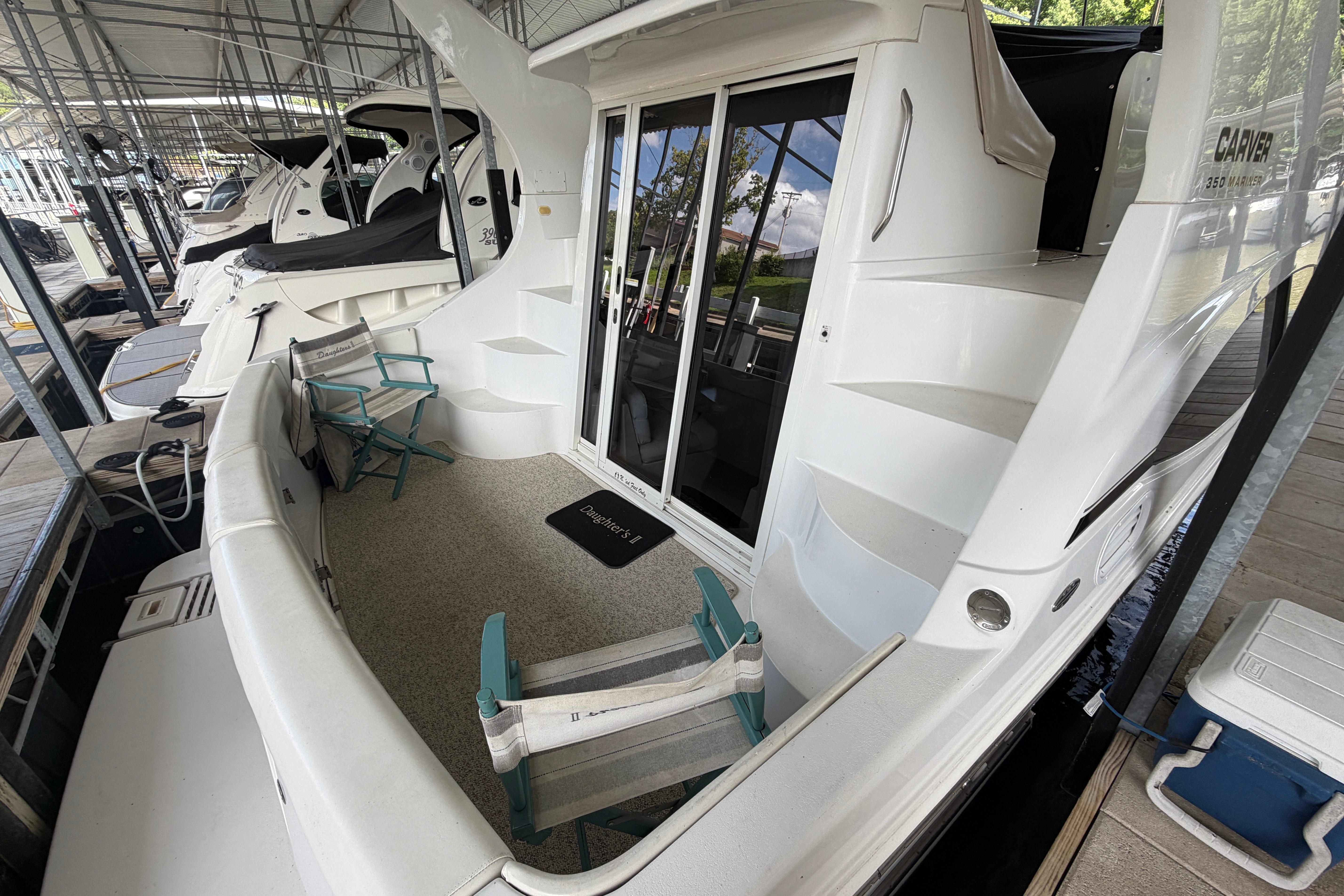 2000 Carver 350 Mariner yacht docked, featuring spacious deck and seating area.