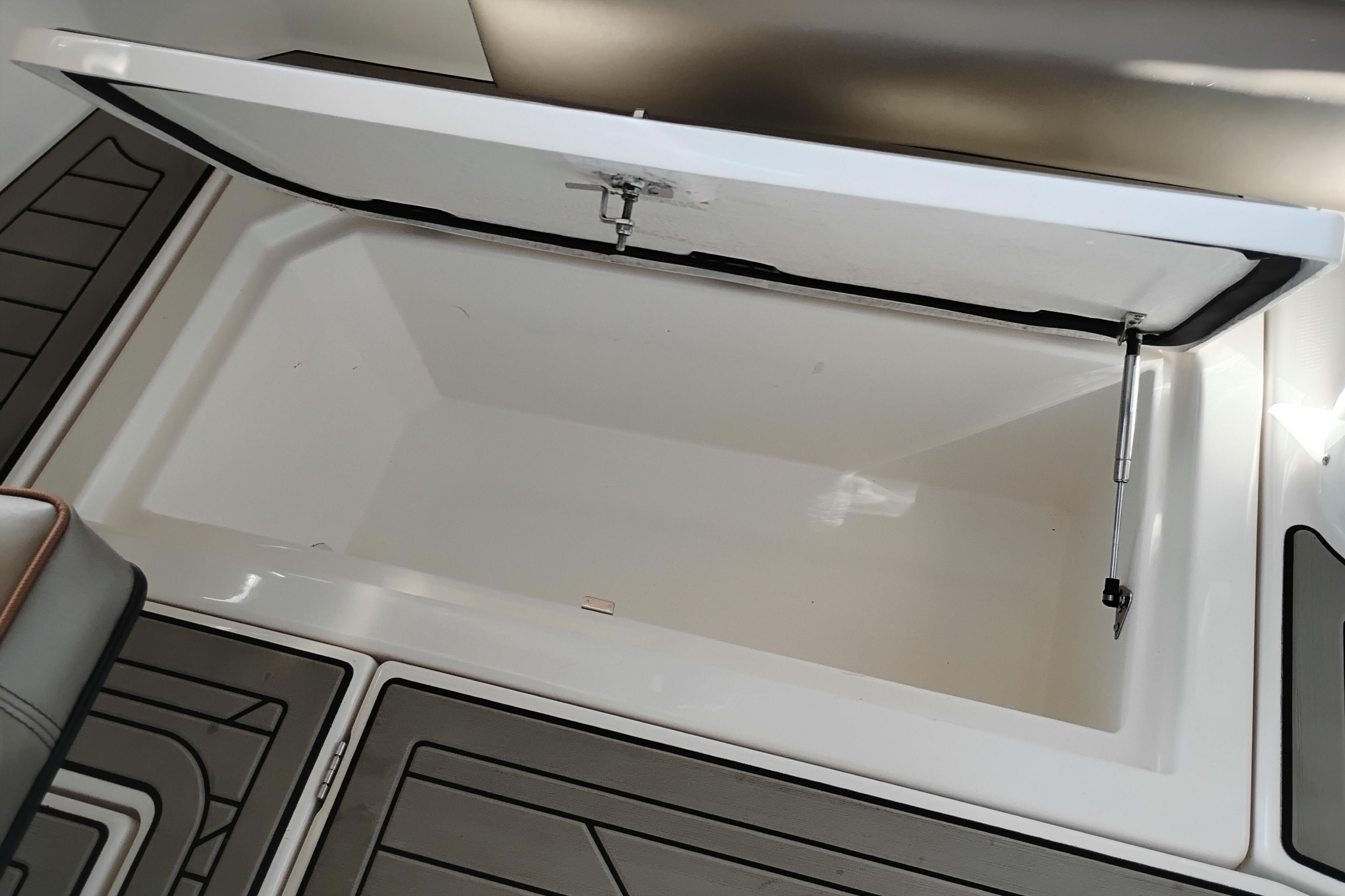 Open storage compartment on 2022 Cutwater C-32 Coupe boat deck.