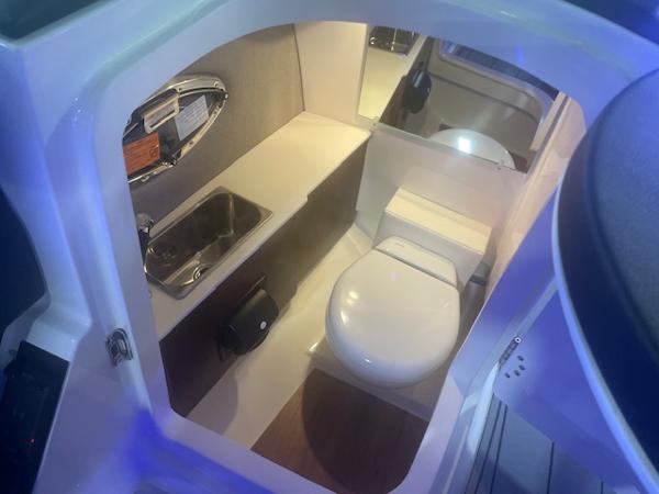 2025 Chaparral 267 SSX boat interior with sink and toilet.