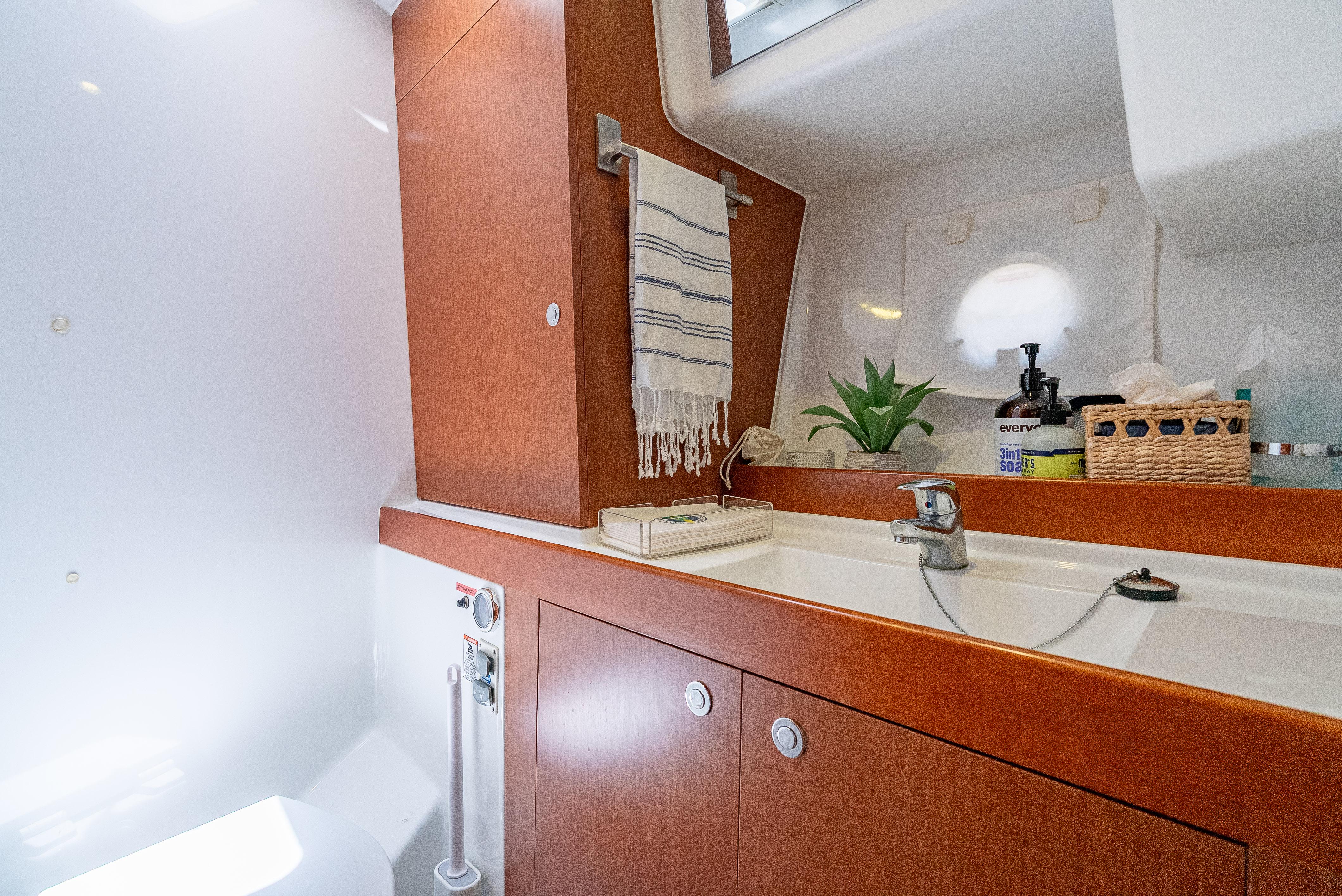 2015 Beneteau Swift Trawler 34 bathroom with wooden cabinetry and modern fixtures.