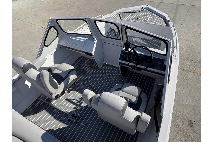 Interior of a 1997 Scully's 18 WT boat with seating and steering console.