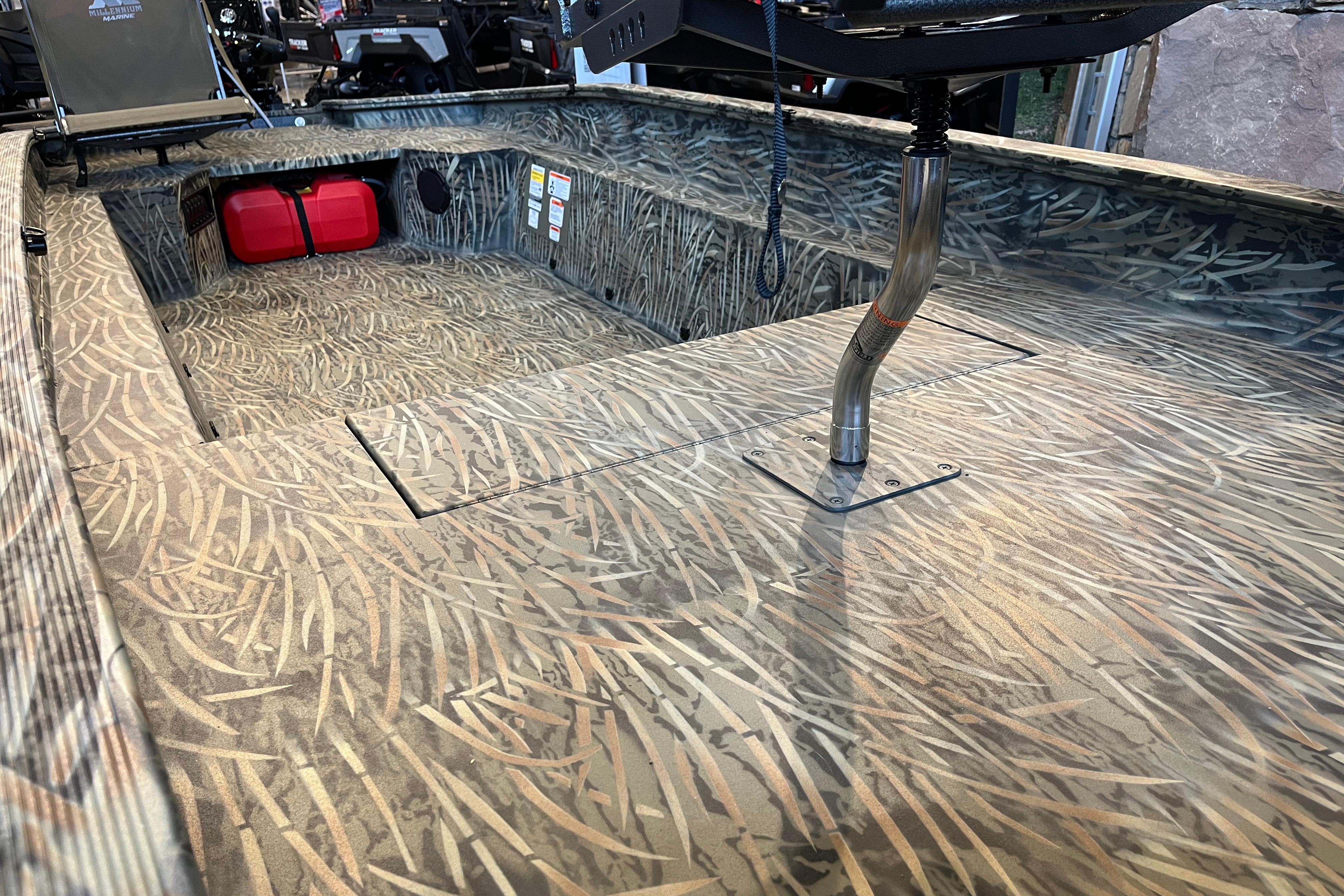 2026 Tracker Grizzly 1654 T Sportsman boat interior with camo pattern and red fuel tank.