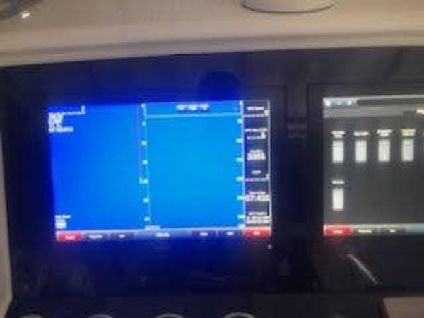 Dashboard of a 2019 Midnight Express 39 Cuddy boat with navigation screens.