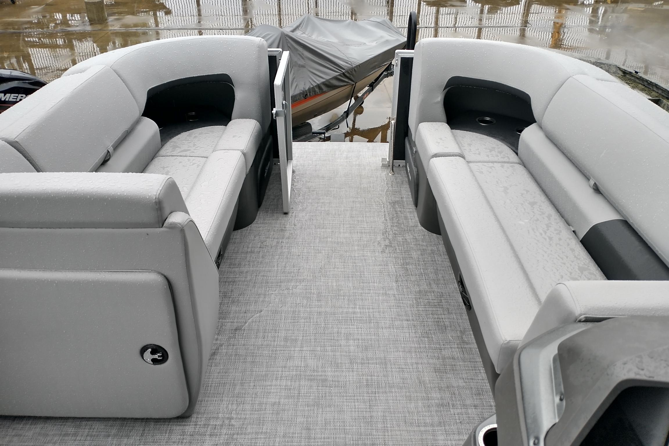 2026 Sun Tracker Party Barge 20 DLX interior with gray seating and open deck.