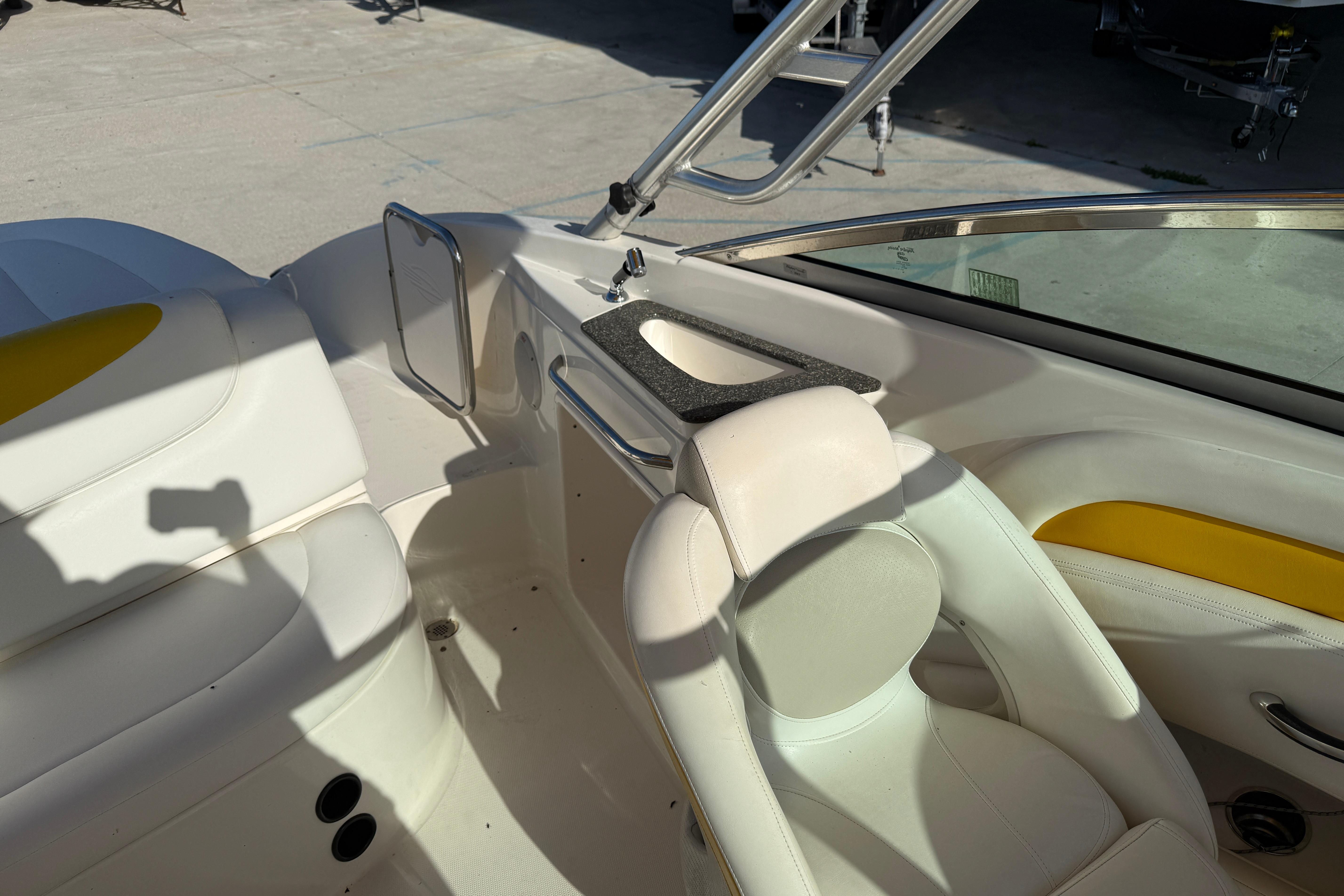 2008 Chaparral 236 SSX boat interior with white seating and yellow accents.