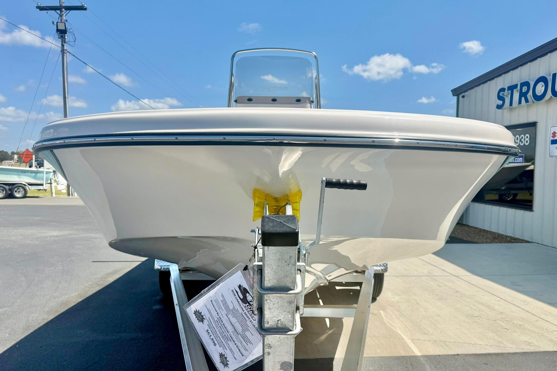 2026 Carolina Skiff 21 Ultra Elite boat on trailer, sunny day, dealership background.