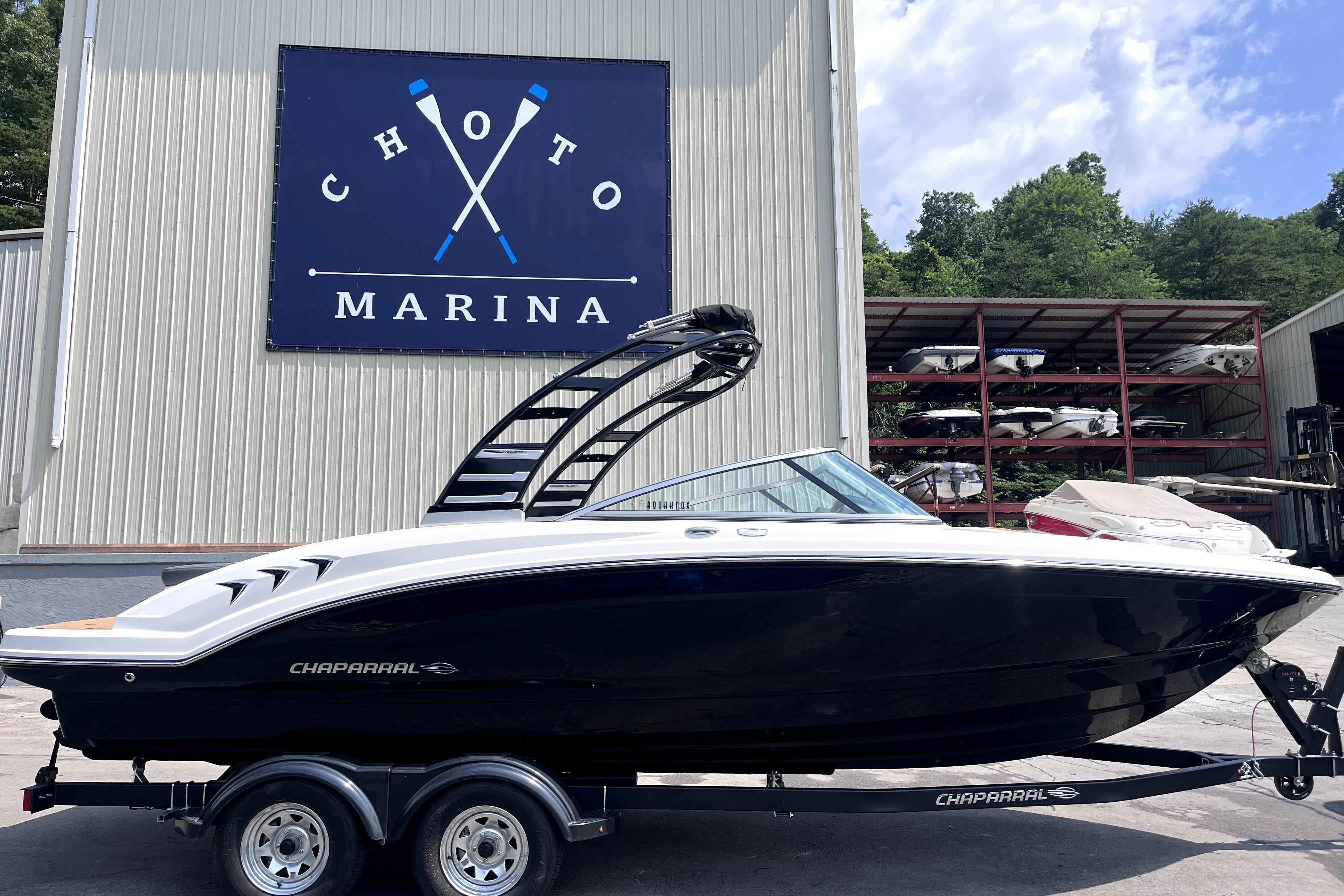 2025 Chaparral 230 SSi boat at Choto Marina, displayed on a trailer.