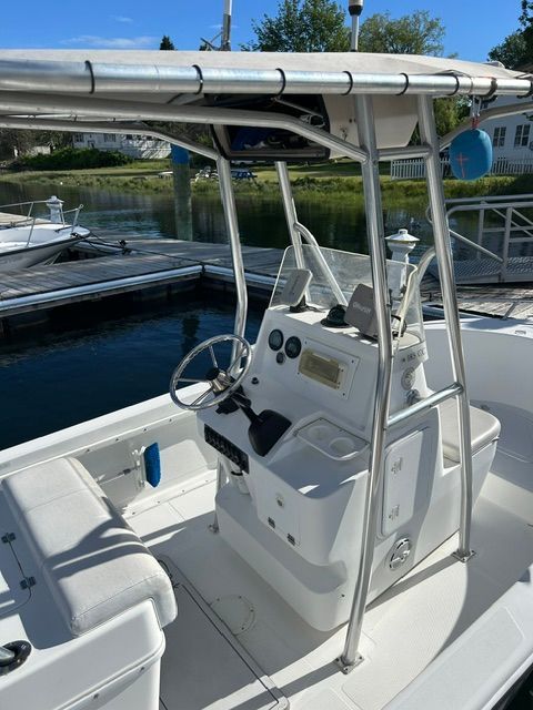 The image shows a 2001 Edgewater 185CC boat with a helm station and T-top.