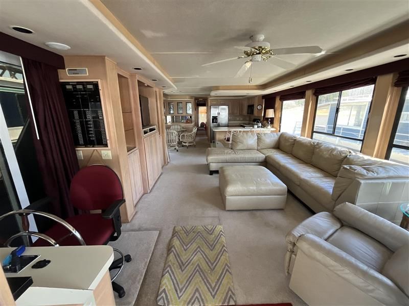 Luxurious 1998 Sumerset houseboat interior with spacious living area, modern kitchen, and comfortable seating.