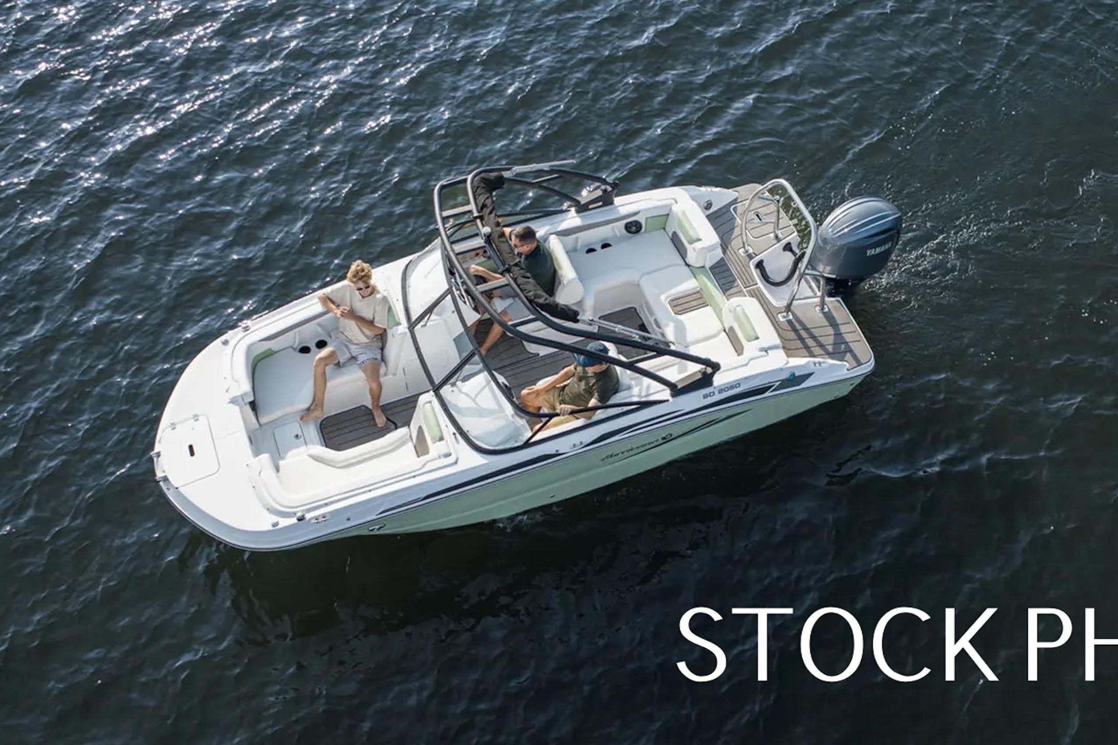 2026 Hurricane SunDeck 2050 OB boat cruising on open water, aerial view.