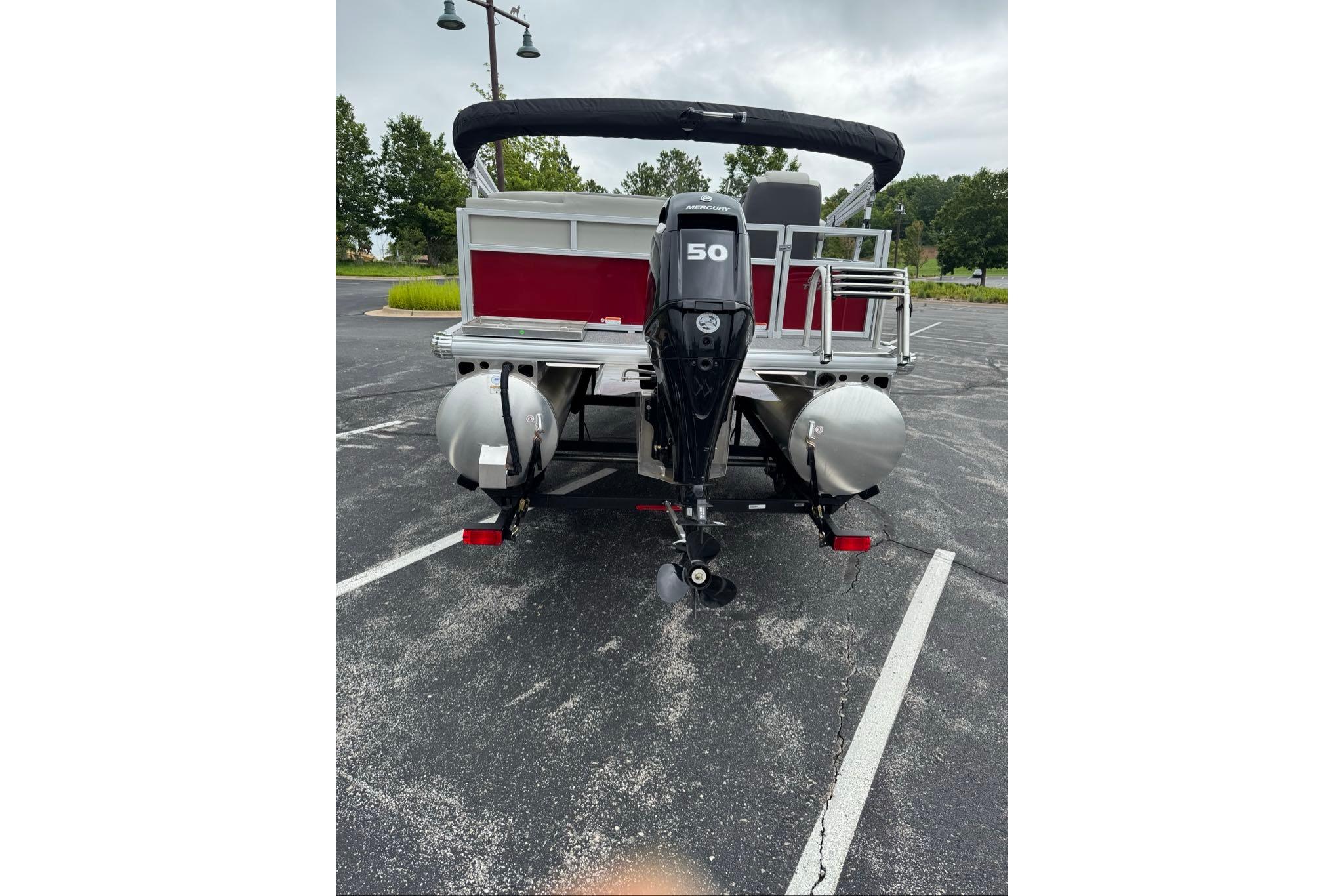 2026 Sun Tracker Bass Buggy 16 XL Select pontoon boat with 50 HP Mercury outboard motor.