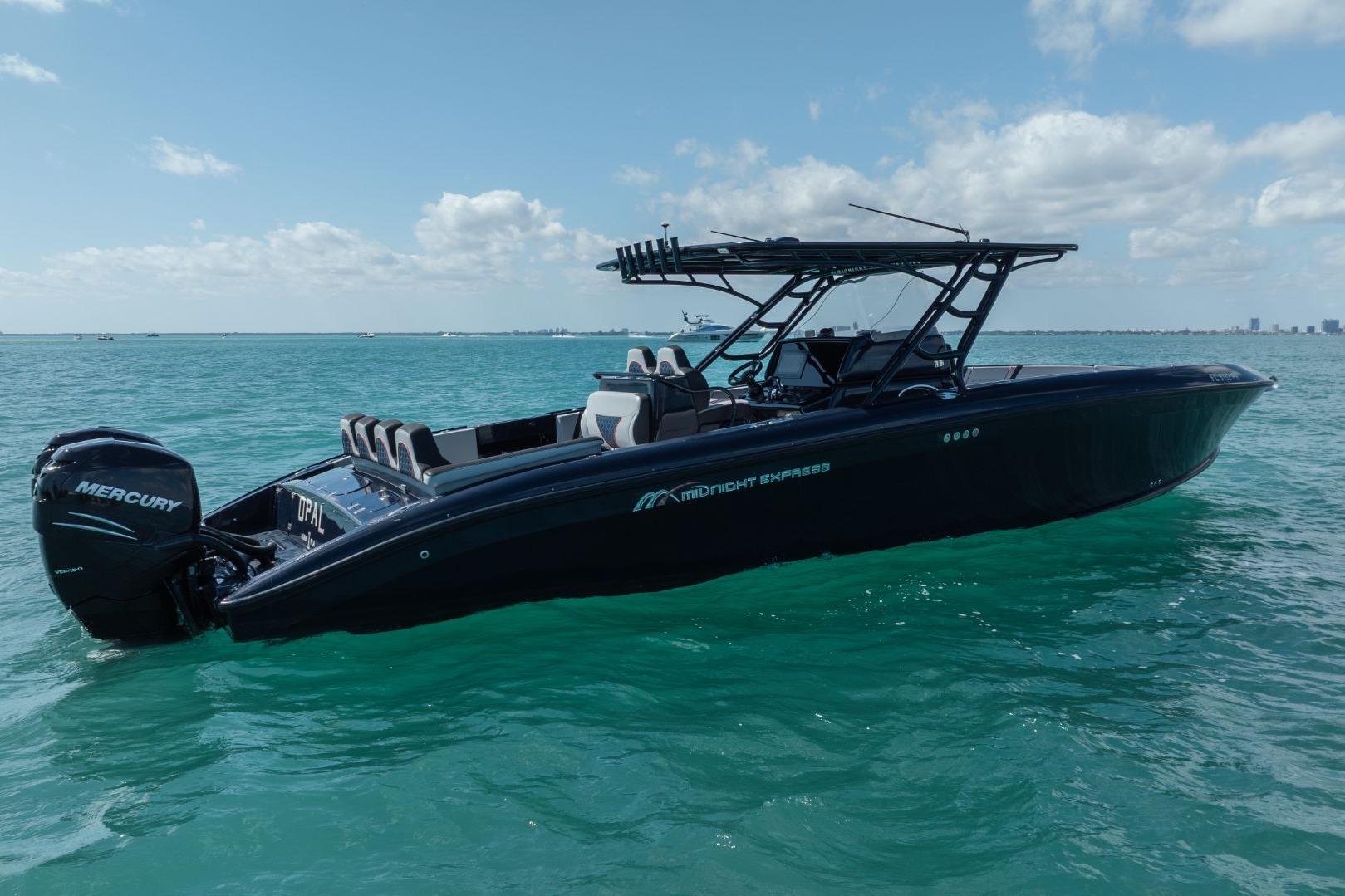 2014 Midnight Express 37 Open boat on turquoise water under blue sky.