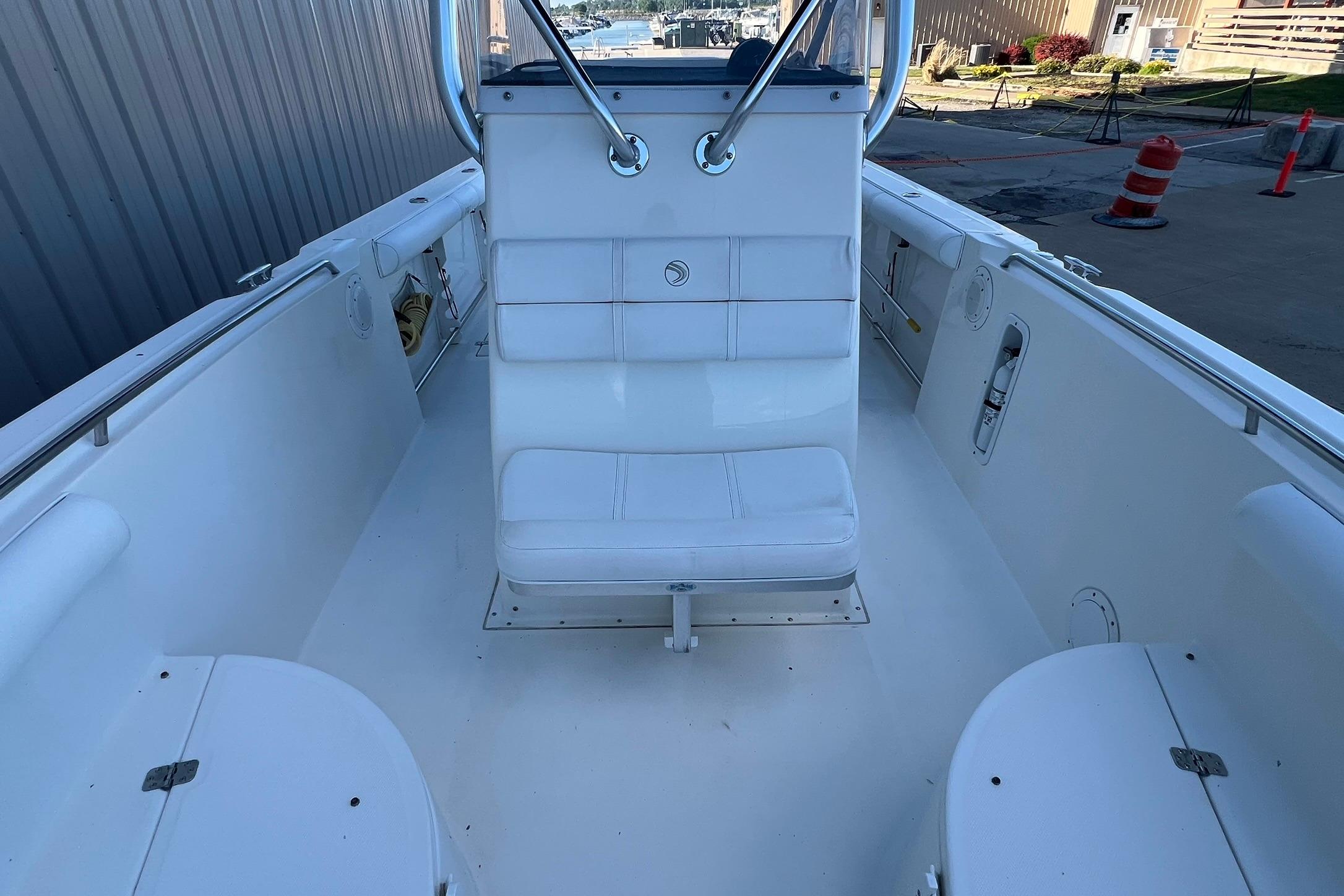 2006 Edgewater 245CC boat interior with white seating and clean deck.