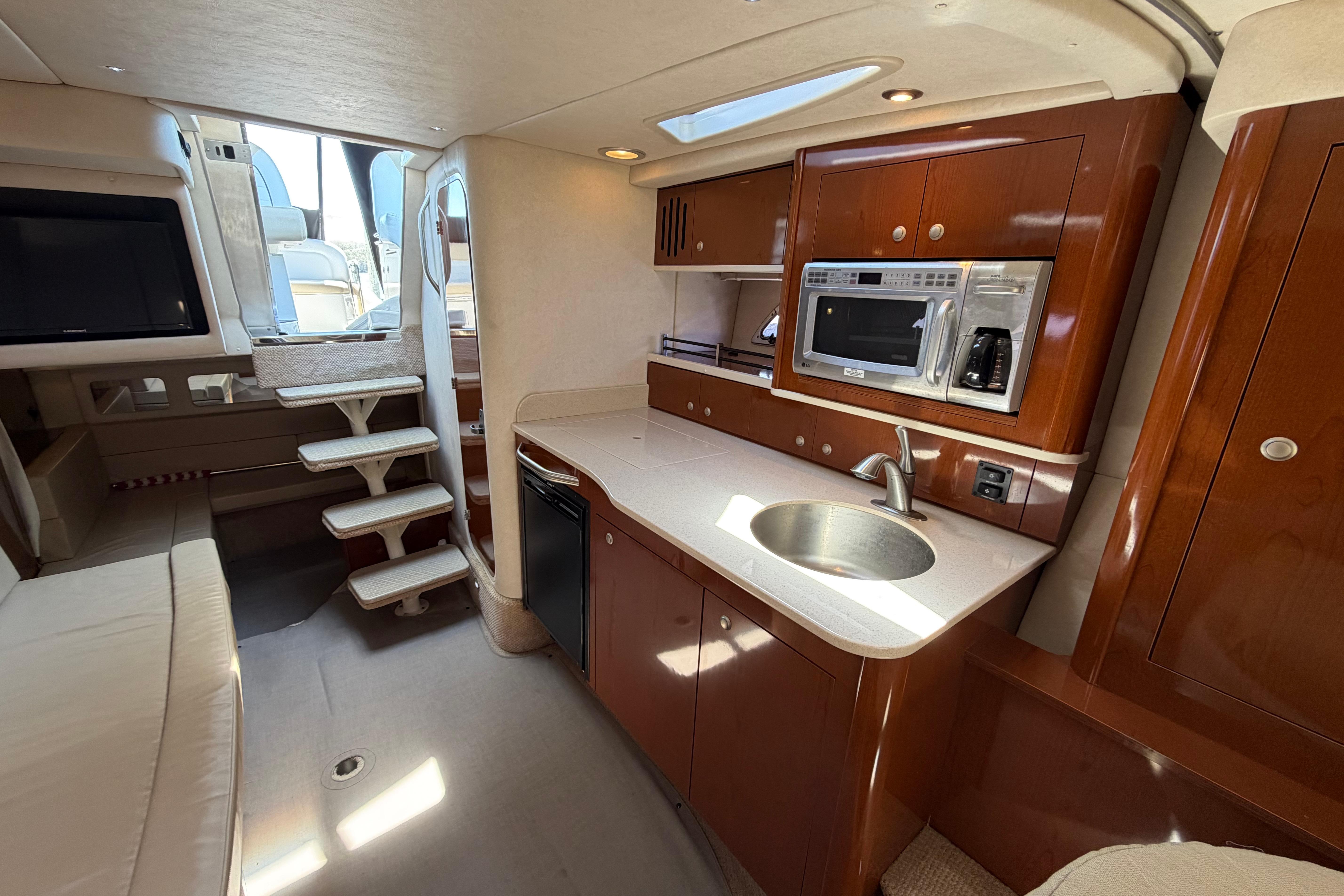 Interior of 2008 Sea Ray Sundancer 330 yacht with kitchenette and seating area.