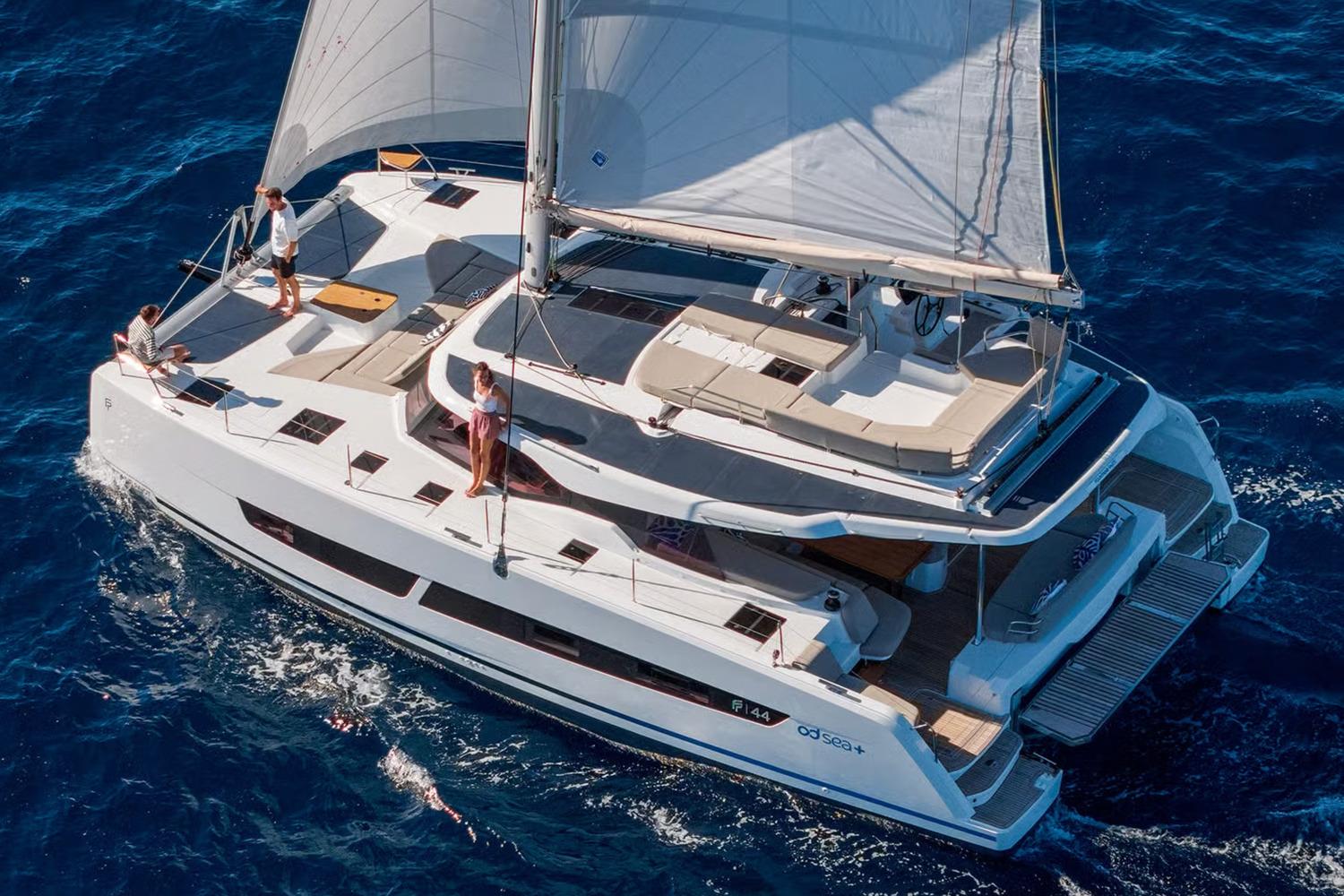 Manufacturer Provided Image: 2026 Fountaine Pajot FP44 Catamaran sailing on open blue sea with passengers onboard.