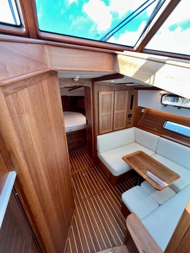 2025 Sabre 43 Salon Express interior with wood finish and white seating.
