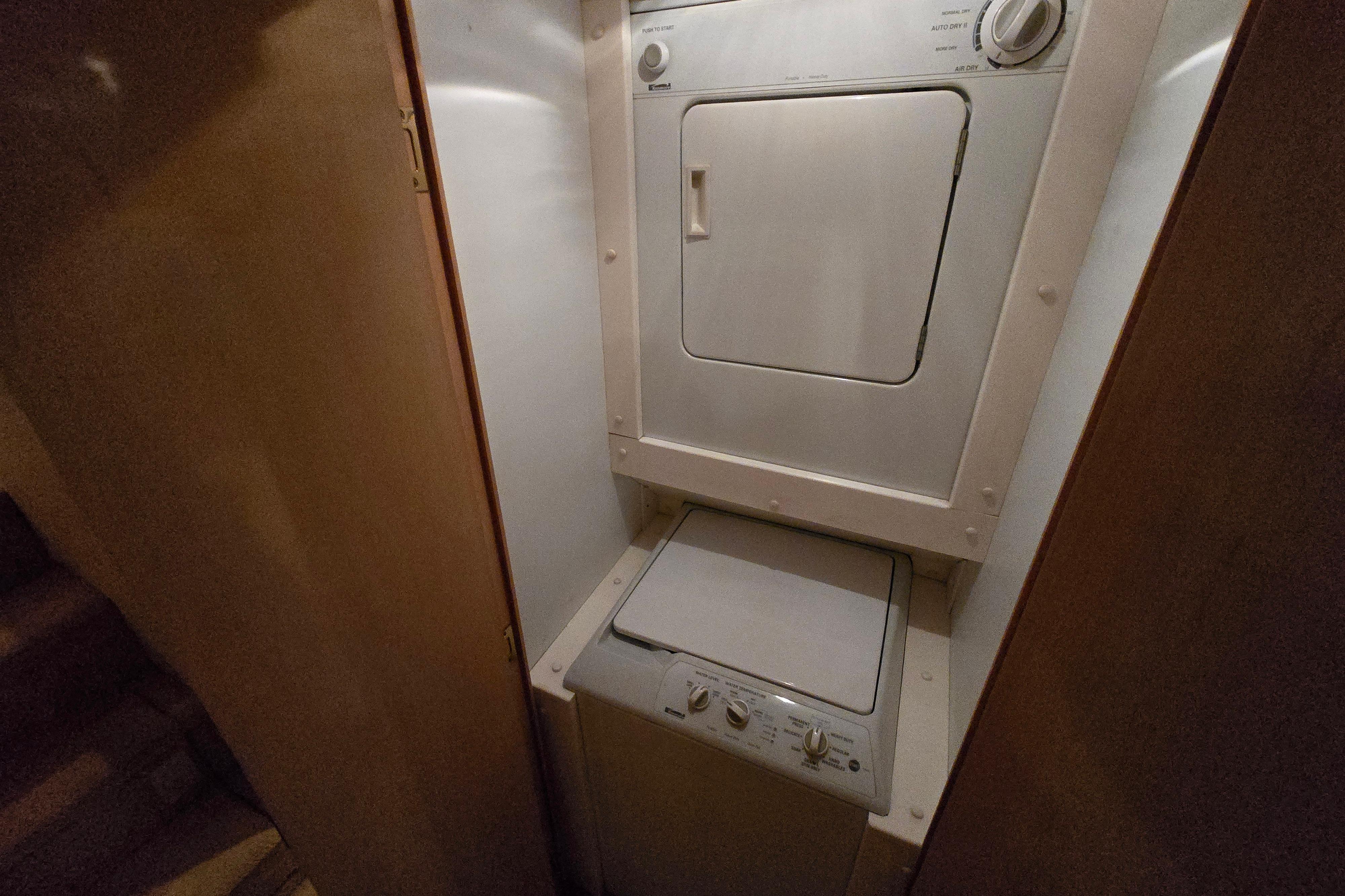 Stacked washer and dryer in 2001 Cavileer 53 Convertible yacht interior.