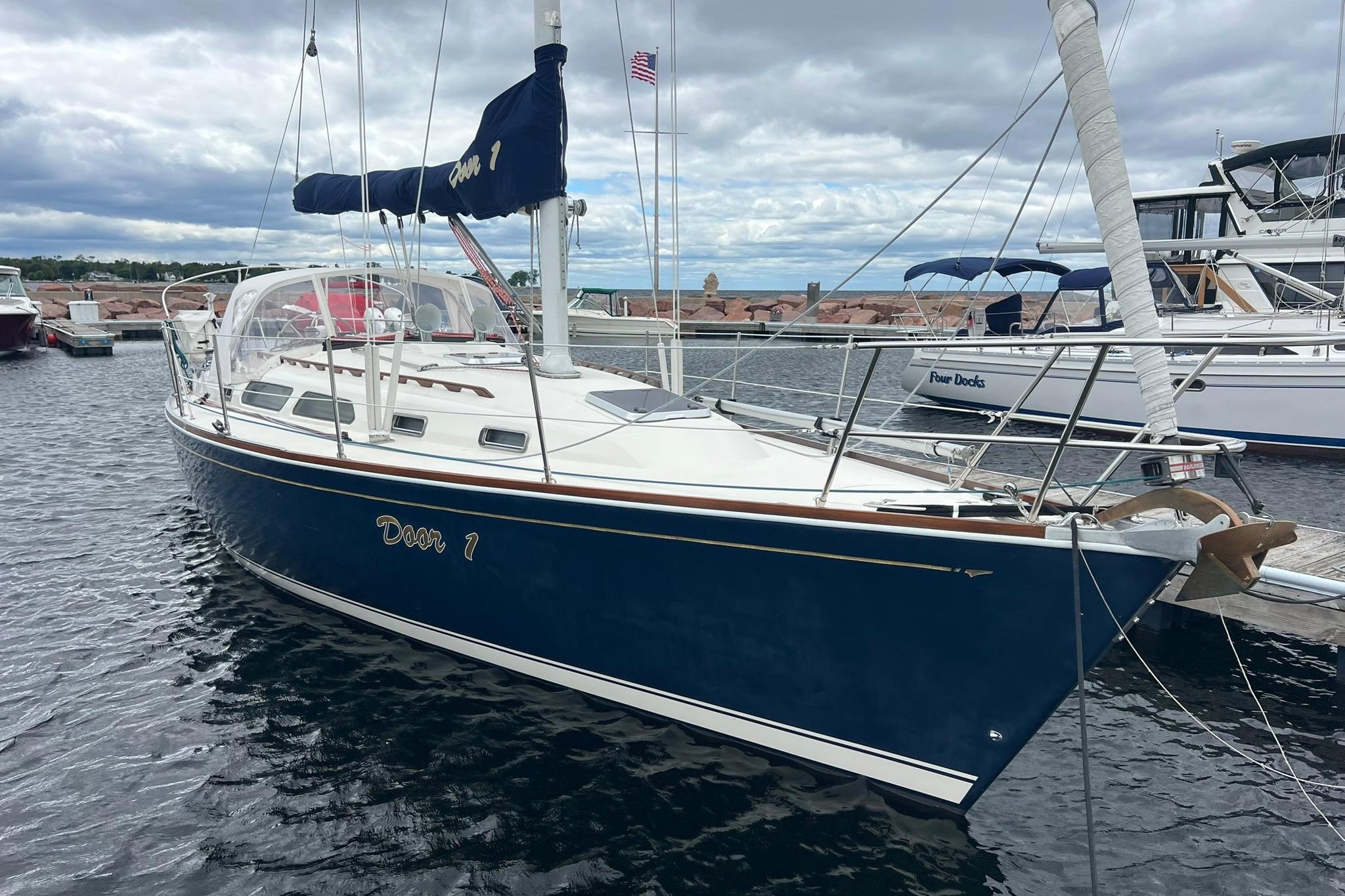 1998 Sabre 362 sailboat docked in a marina, featuring a sleek blue hull.