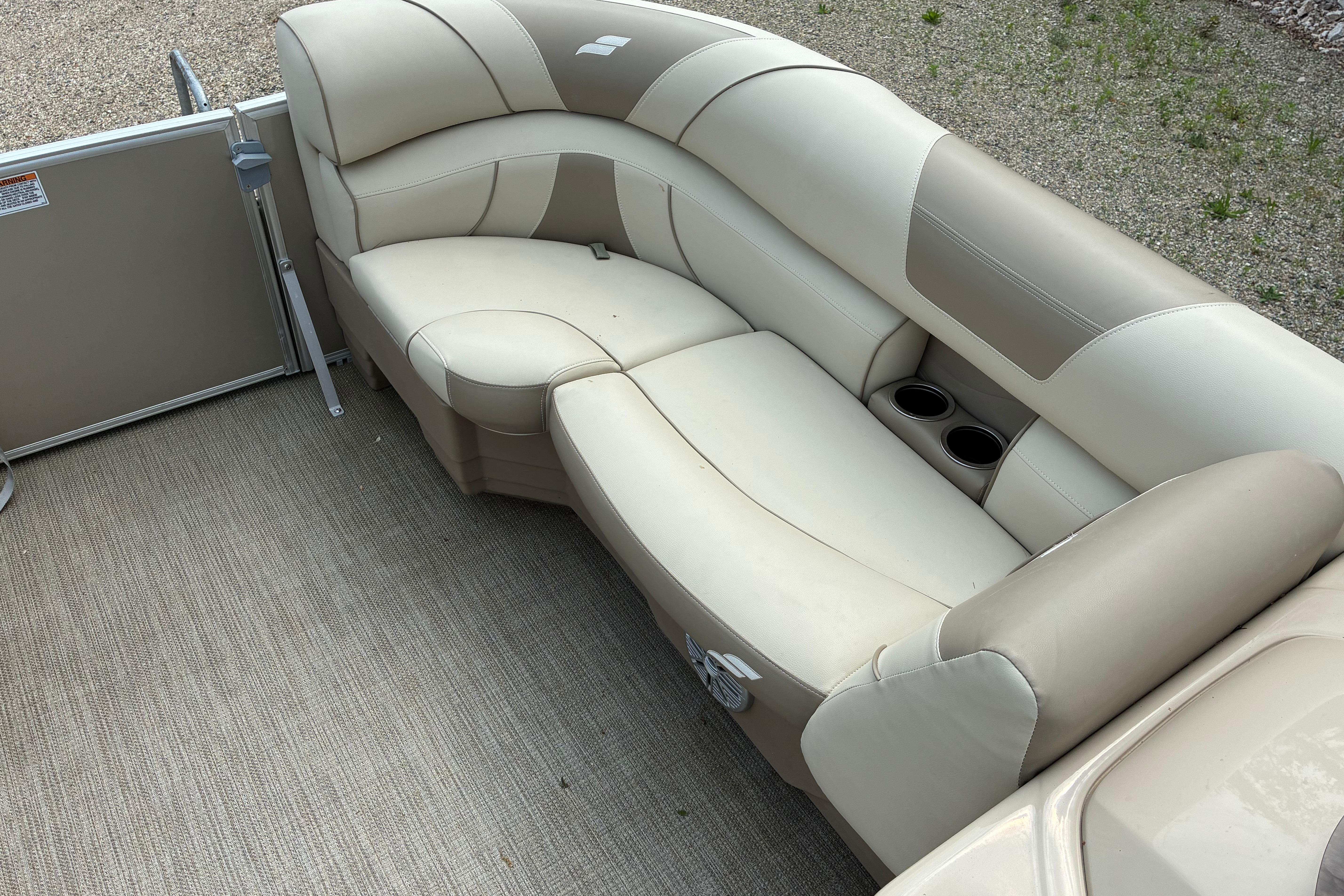 2020 Starcraft EX 20 C boat interior with beige seating and cup holders.