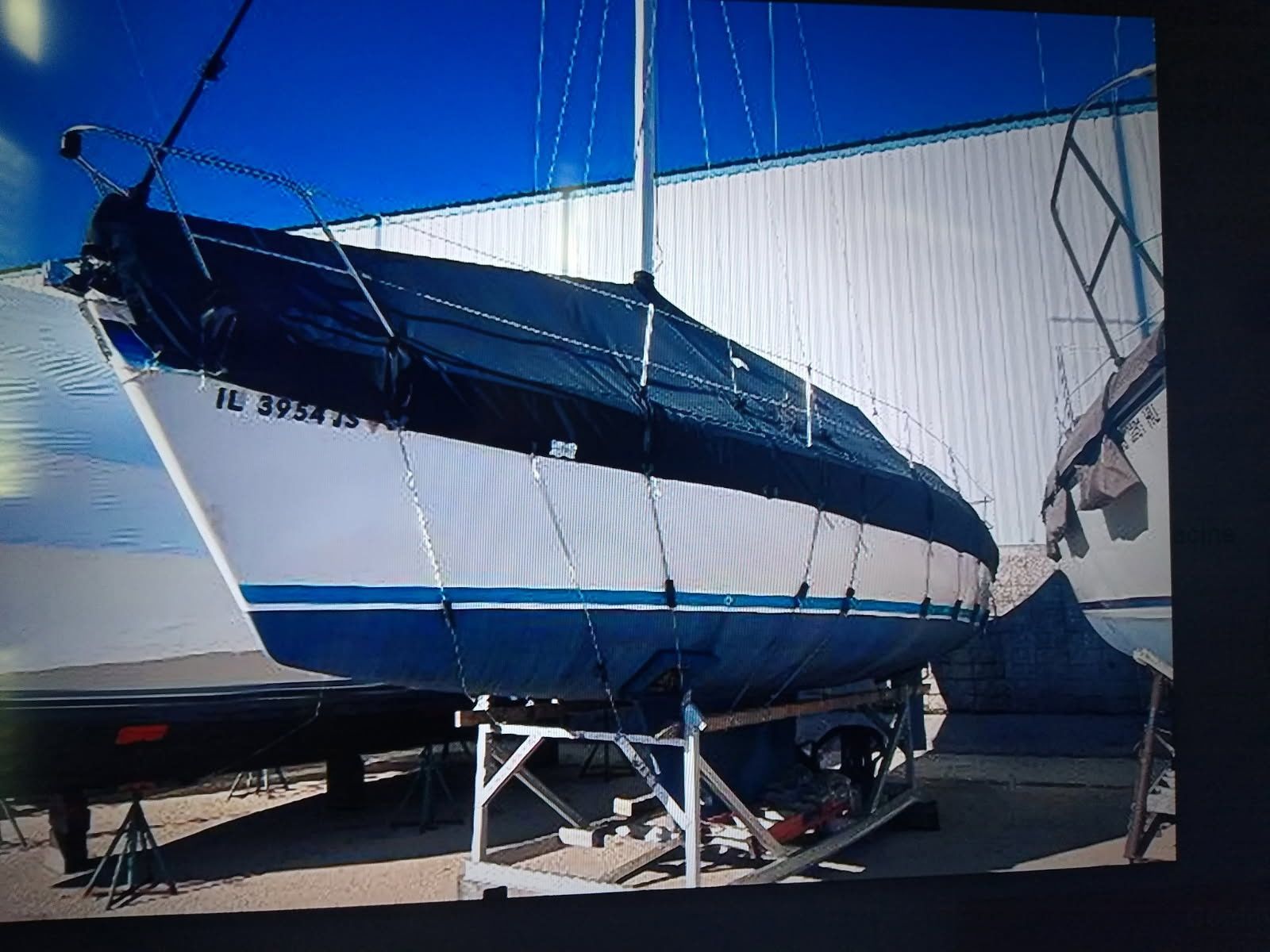 1986 Laguna 30 sailboat on a stand outdoors.