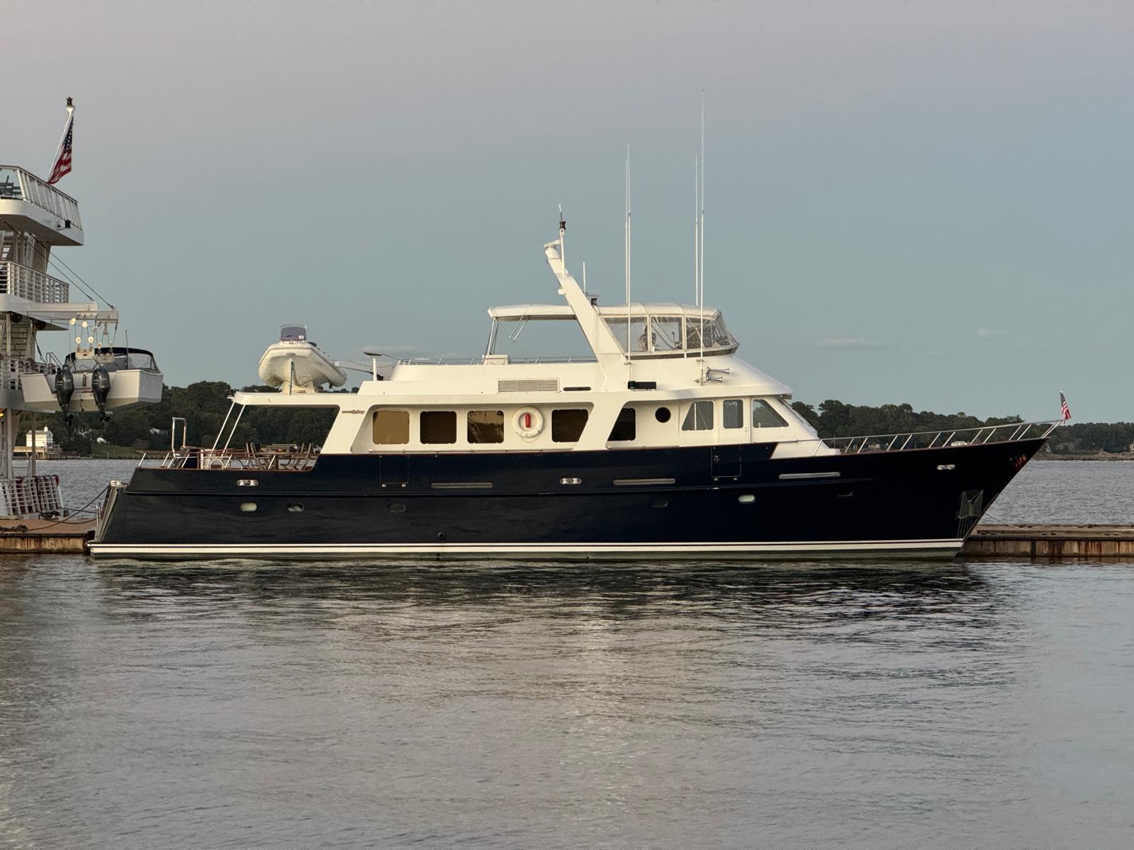 1987 Jongert 78 Motor Yacht docked, featuring sleek design with blue hull and white superstructure.