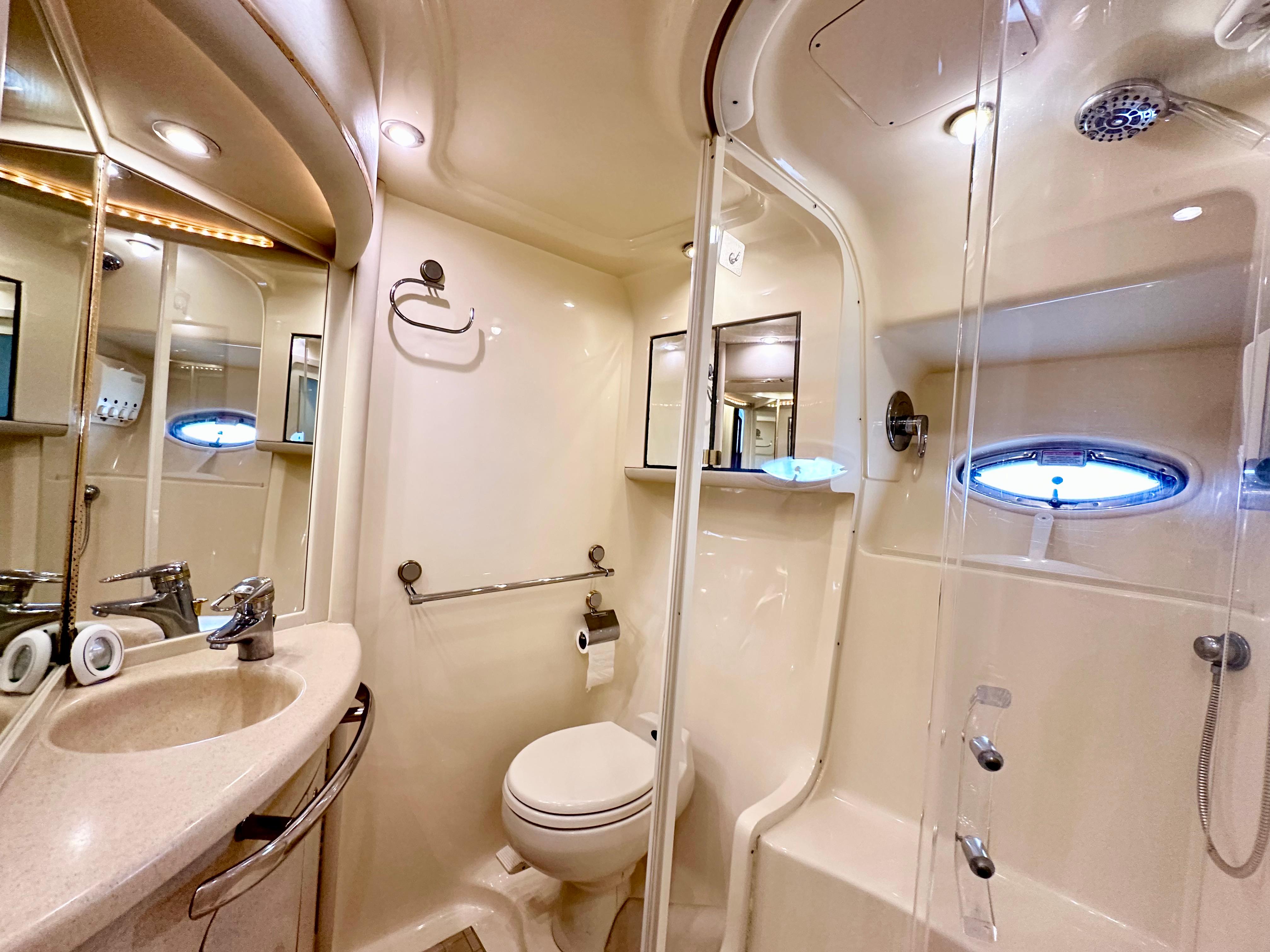 Luxurious bathroom in 2002 Sea Ray 560 Sedan Bridge yacht with modern fixtures.