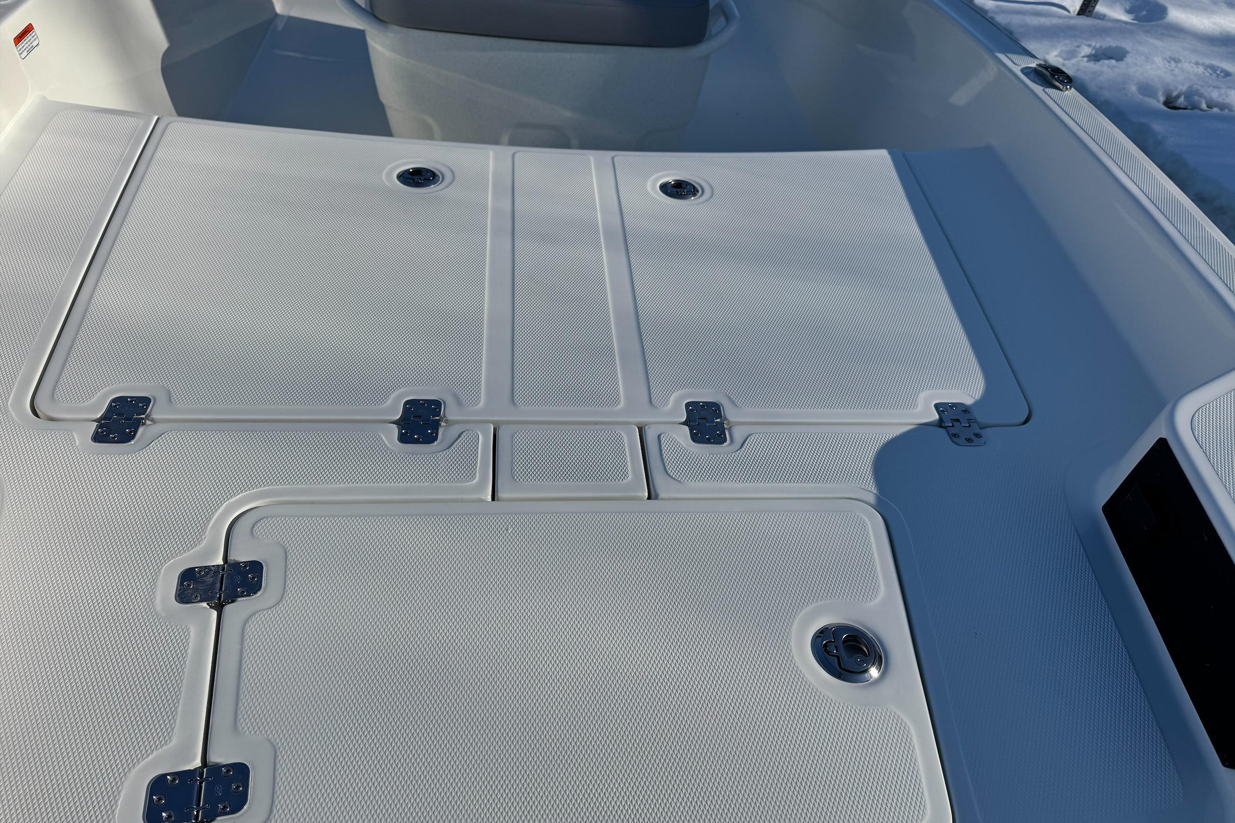 2026 Mako Pro Skiff 15 CC boat deck with storage compartments and textured surface.