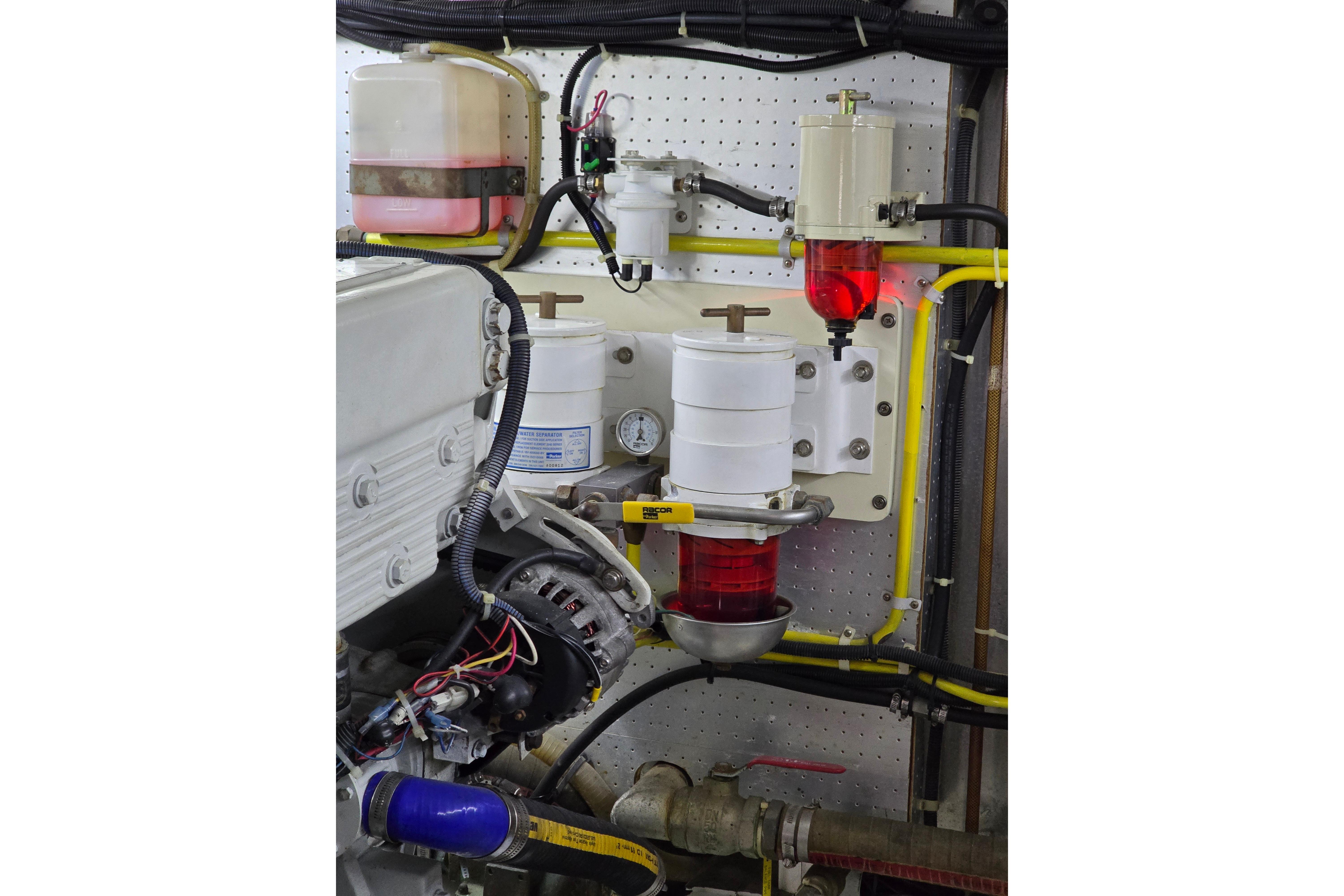 Engine room of 2004 Grand Harbour 58 yacht with fuel filters and wiring.