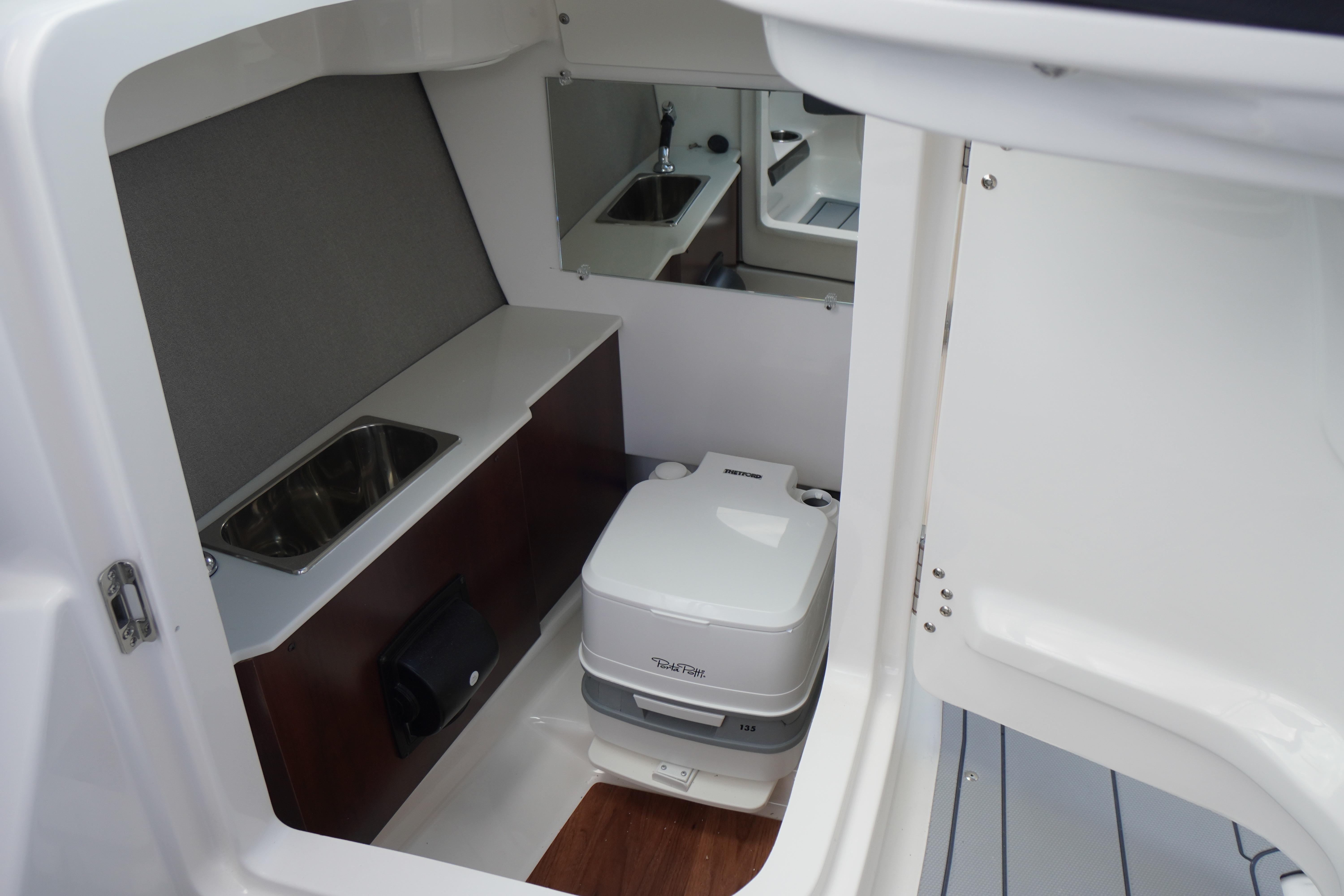 2026 Chaparral SSX 4 boat interior with sink and portable toilet.