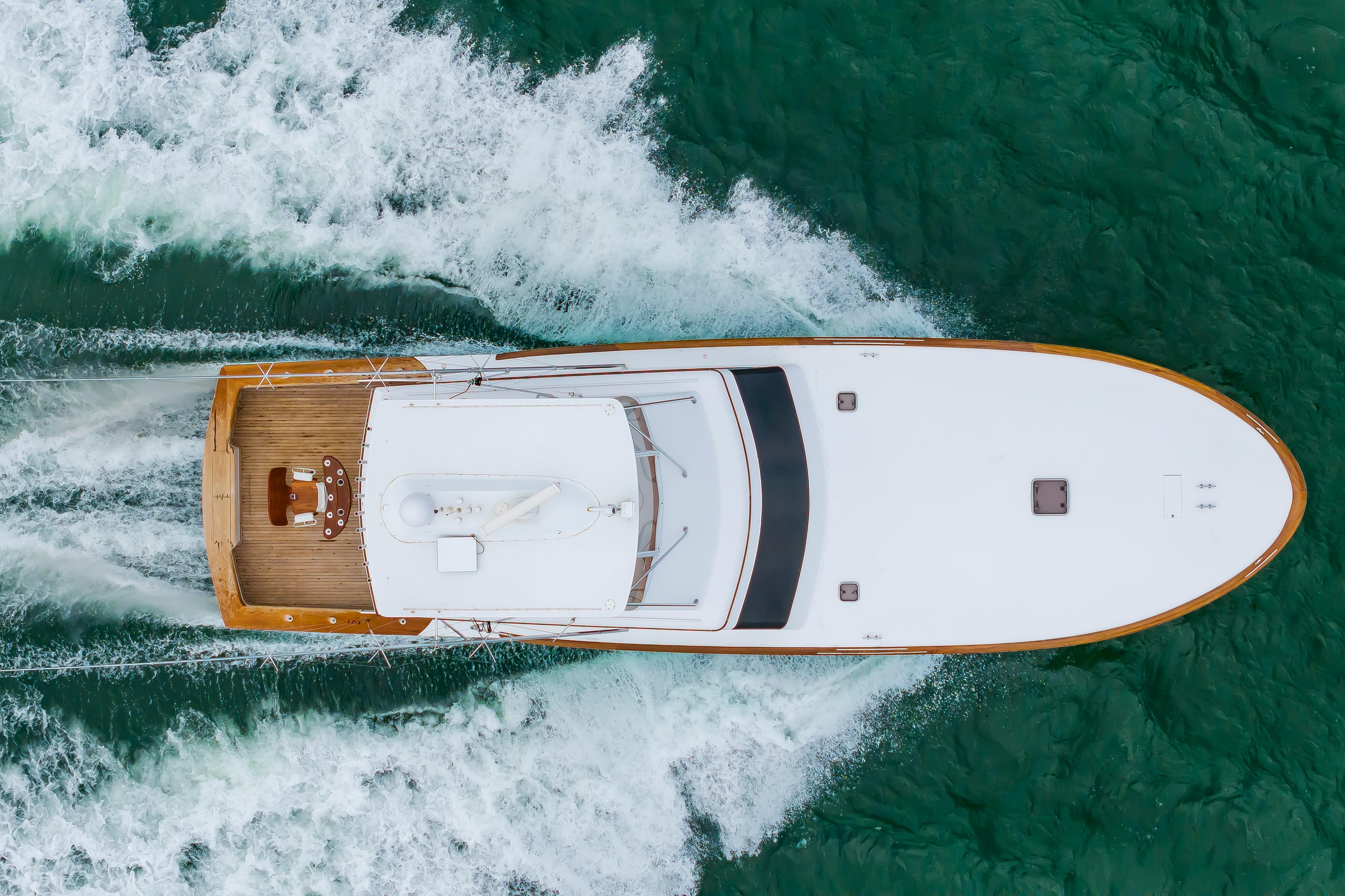 Aerial view of 1993 Custom Carolina Scarborough 56 Convertible yacht cruising on turquoise water.