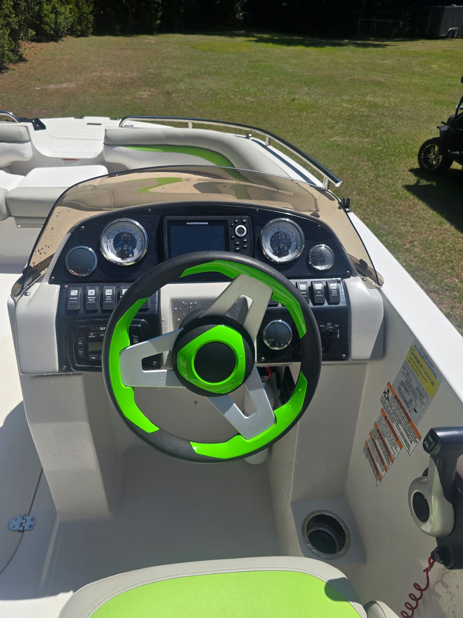 The image shows the helm of a 2017 Starcraft MDX 191 OB with a green steering wheel.