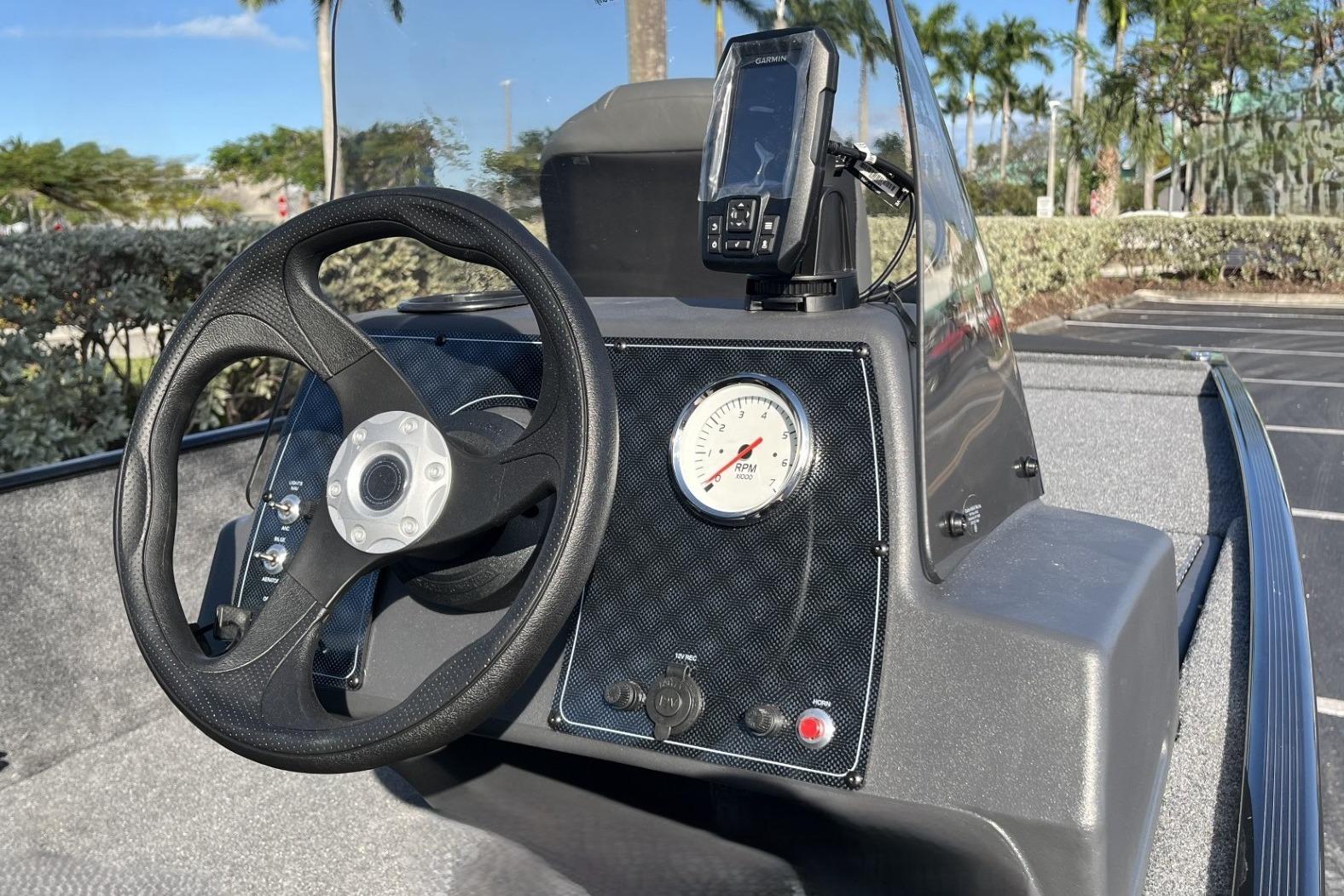 Steering console of 2026 Tracker Bass Tracker Classic XL boat with RPM gauge and GPS device.