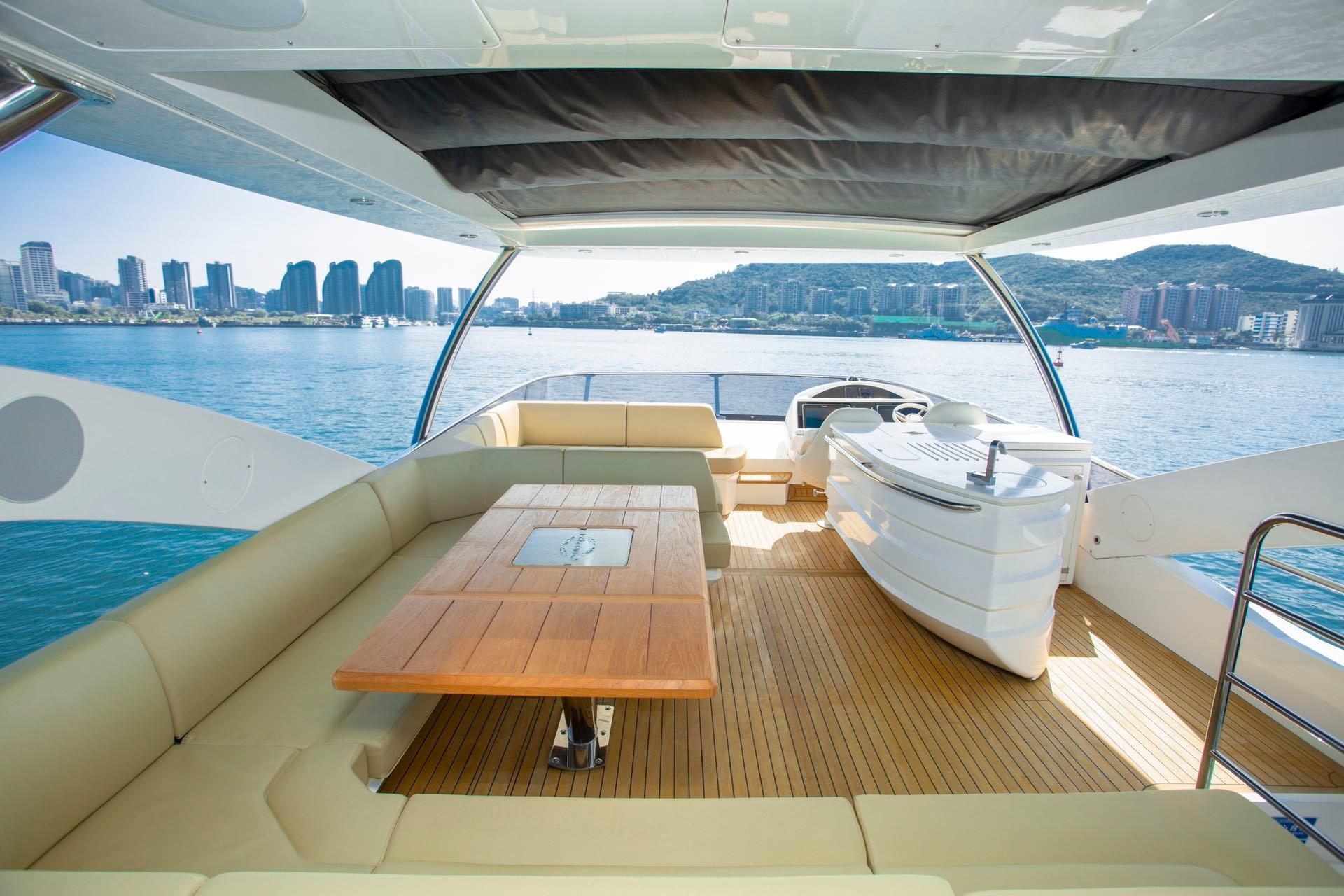 Luxurious 2016 Sunseeker 75 Yacht interior with scenic ocean and city skyline views.