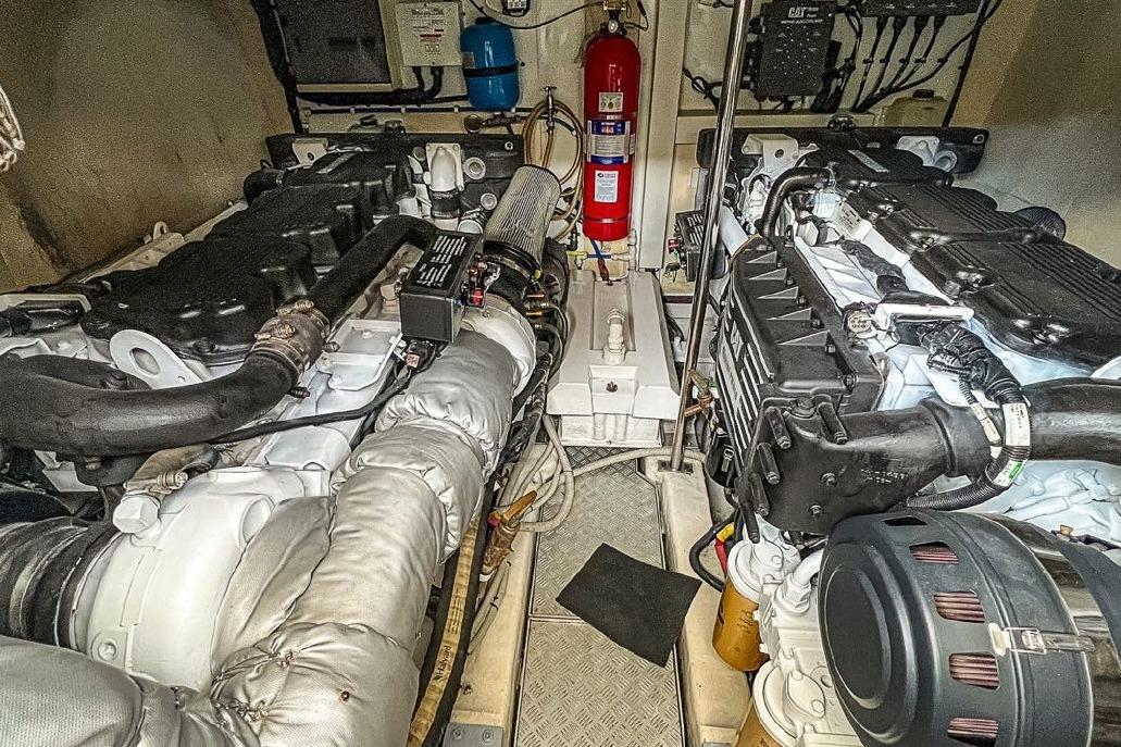 Engine room of 2008 Princess 62 Flybridge yacht, featuring dual engines and fire extinguisher.