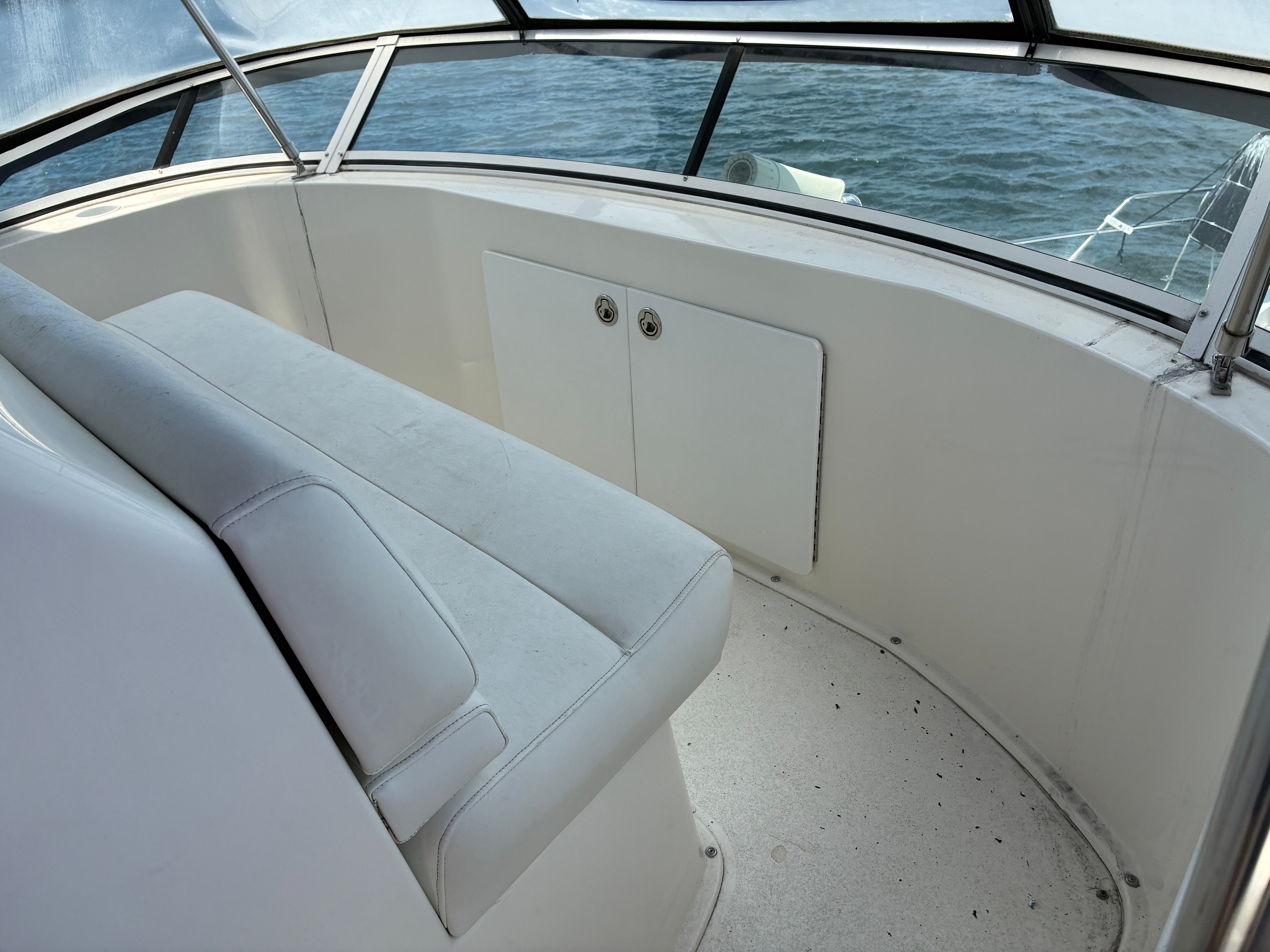 The image shows the seating area of a 2001 Silverton 392 Motor Yacht with a view of the water.