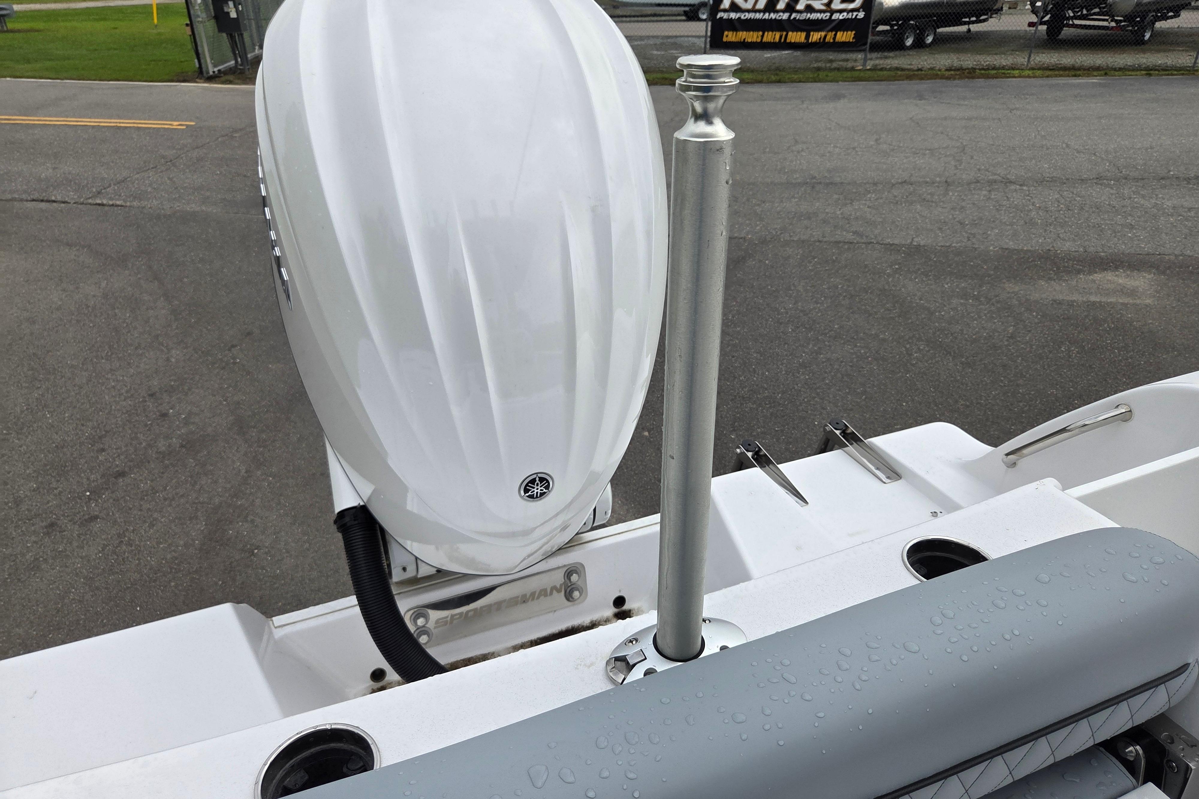 2026 Sportsman Open 232 Center Console boat with sleek white motor and wet seating area.