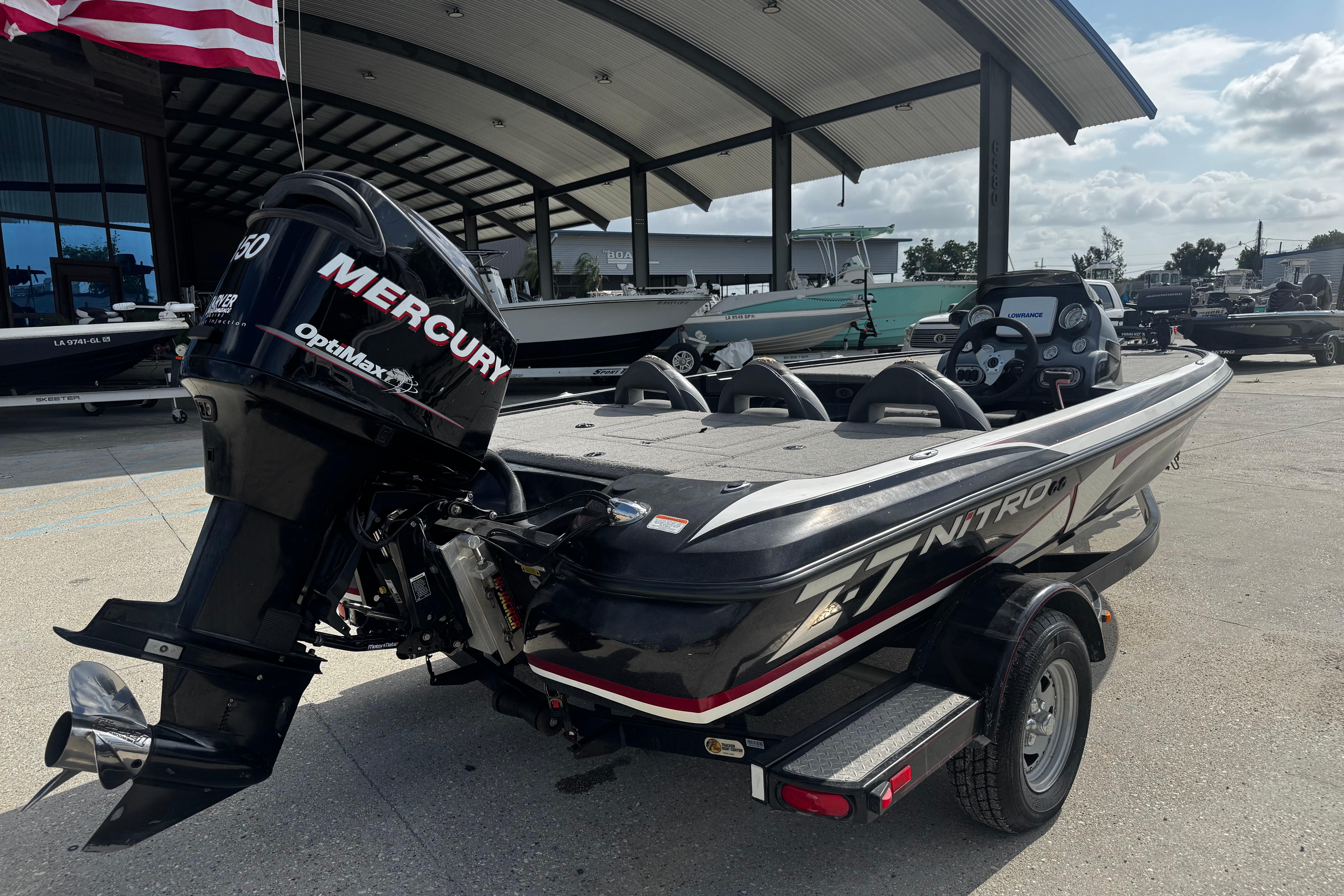 2012 Nitro Z-7 boat with Mercury OptiMax engine, parked under a canopy.
