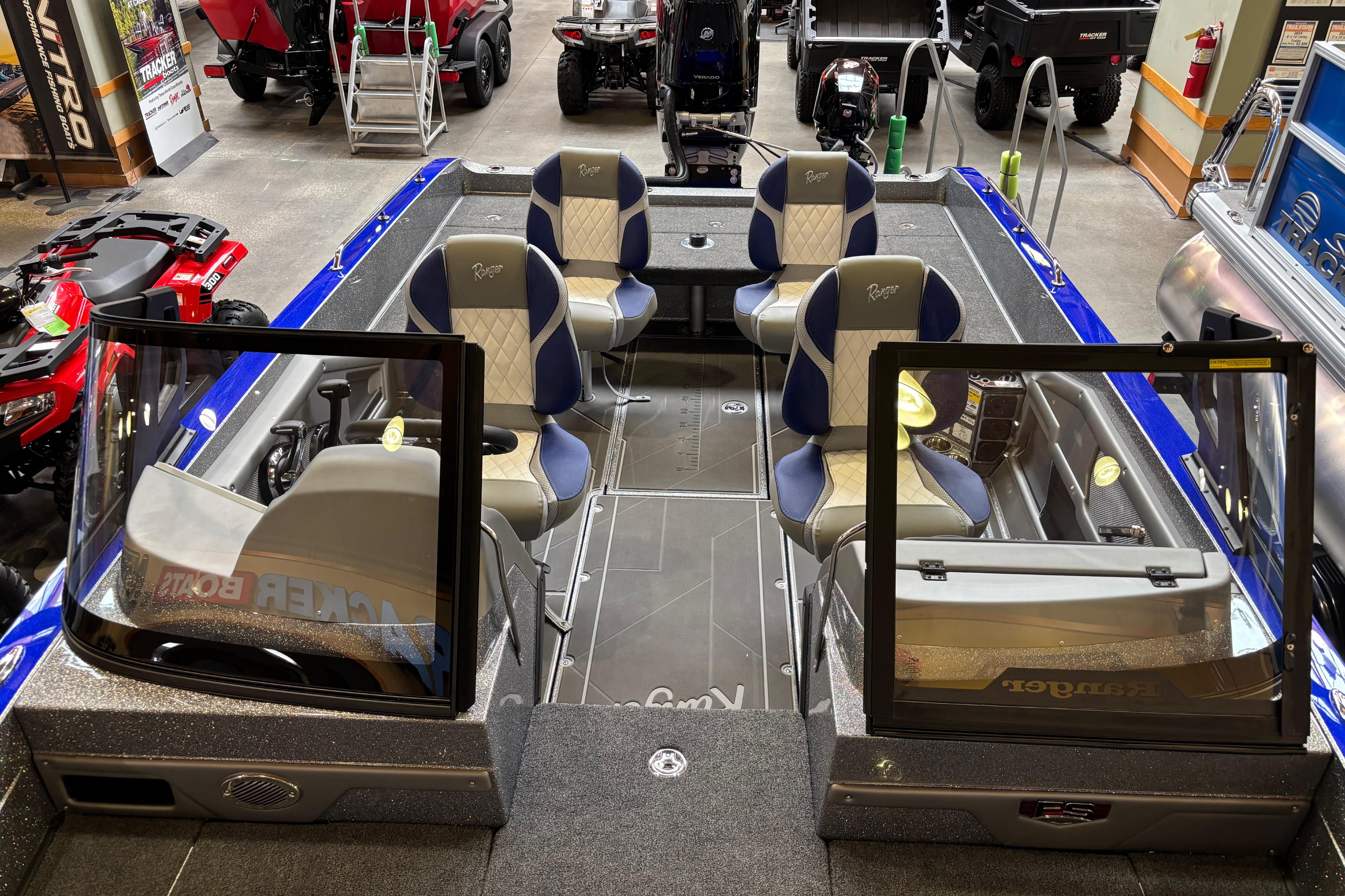 2026 Ranger 621FS Cup-Equipped boat interior with seating and controls in showroom.