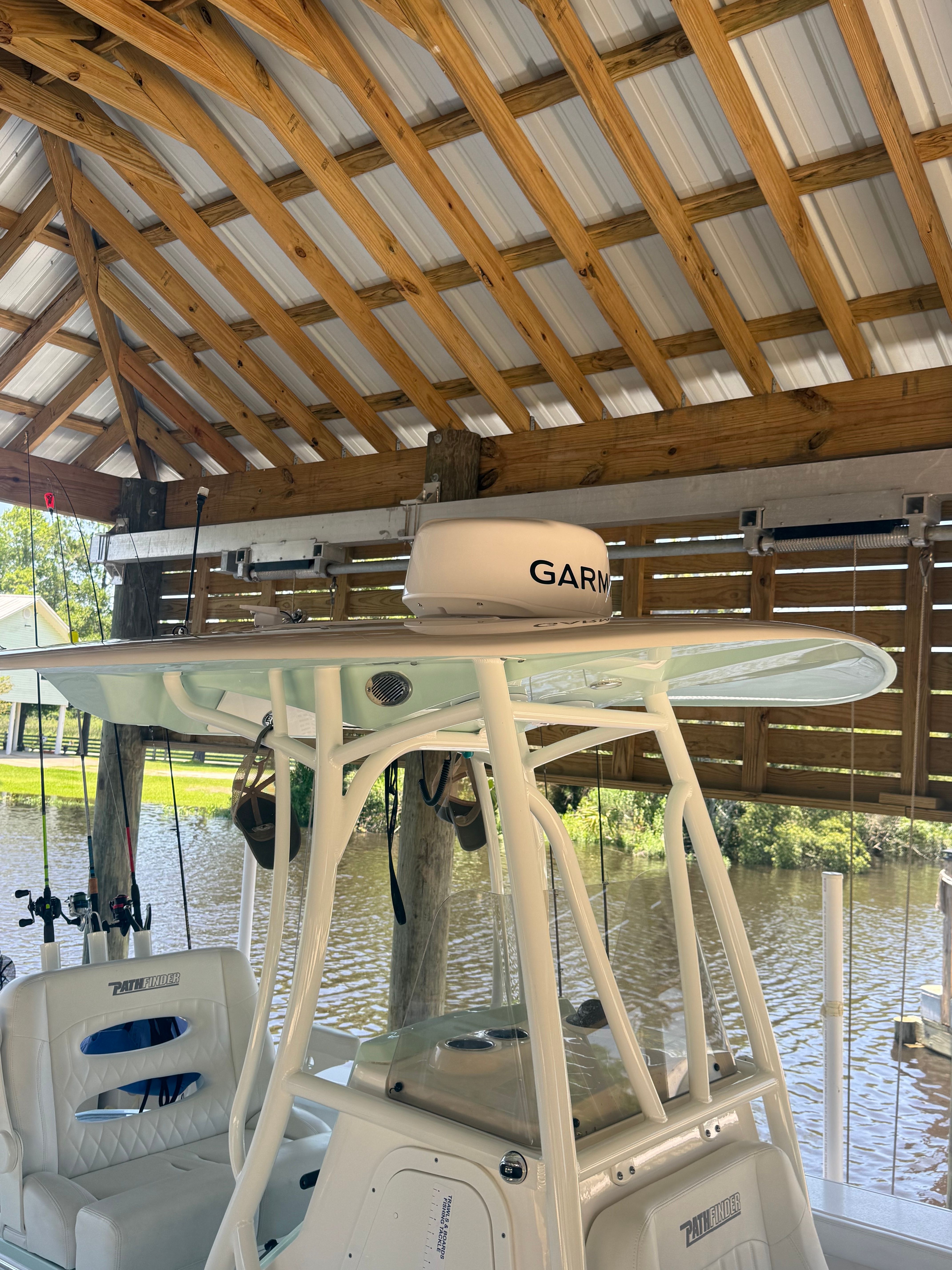 Pathfinder 2700 Open 2024 under a covered boathouse.