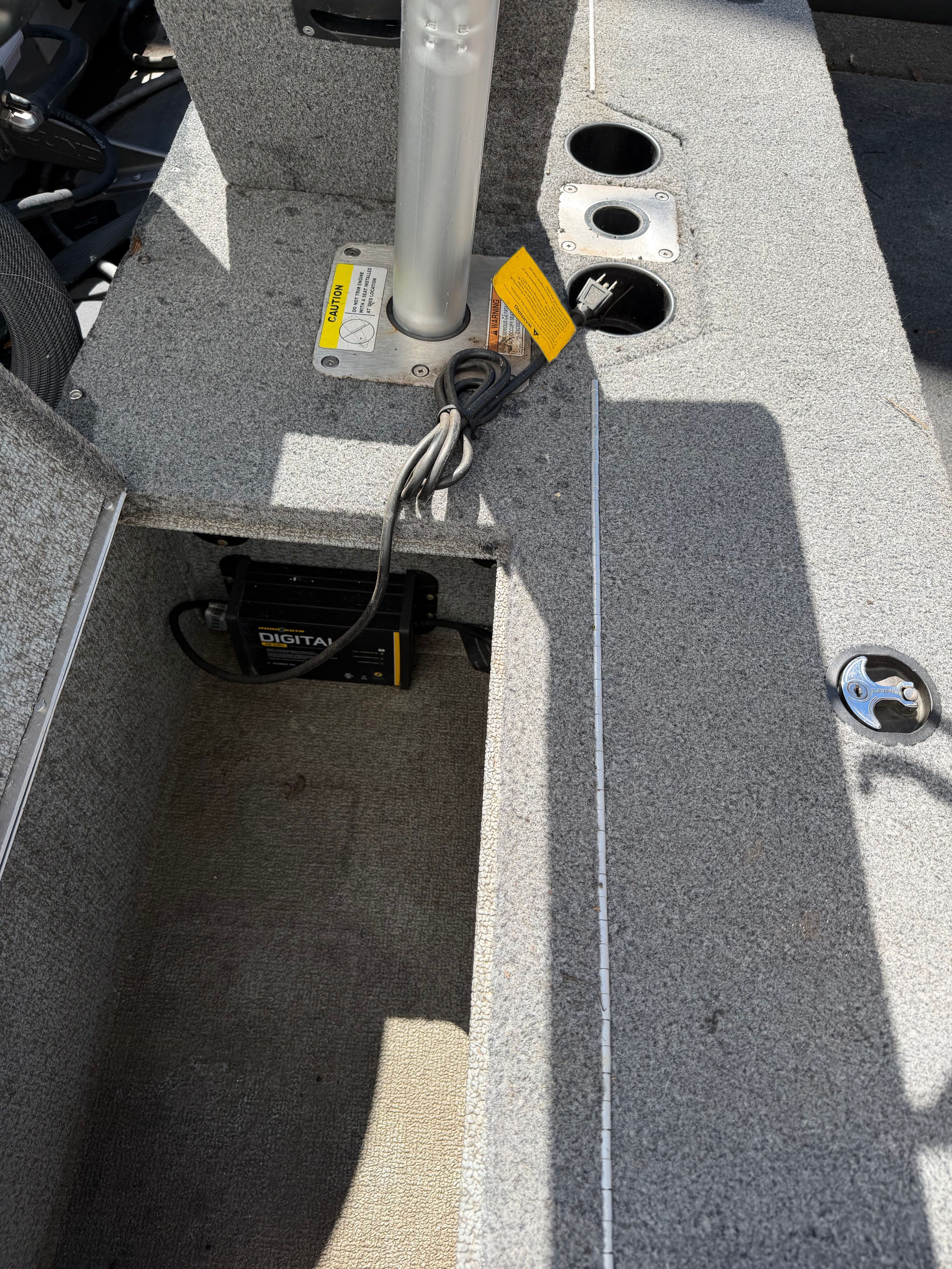 Interior of a 2017 Lund Pro v 1975 boat with cables and mounts.