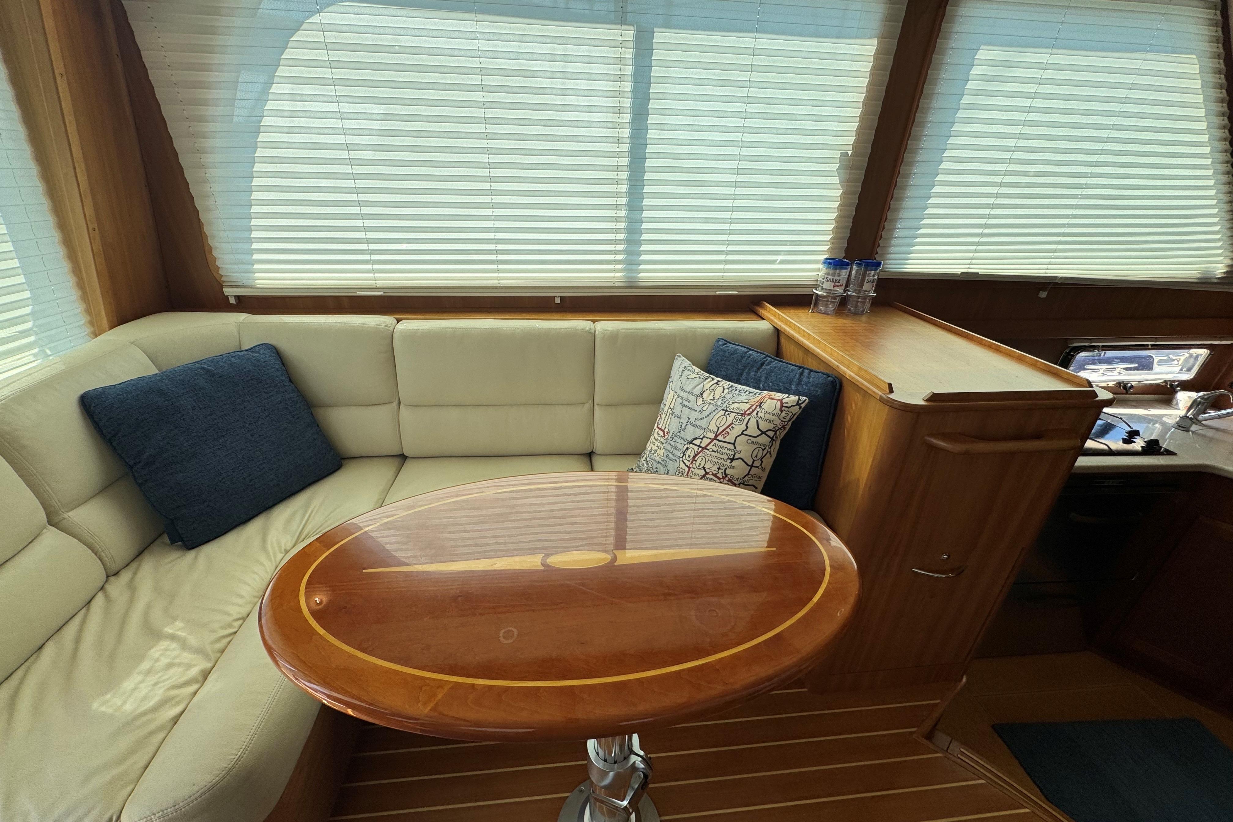 Interior of 2016 Sabre Craft Salon Express with cozy seating and wooden table.