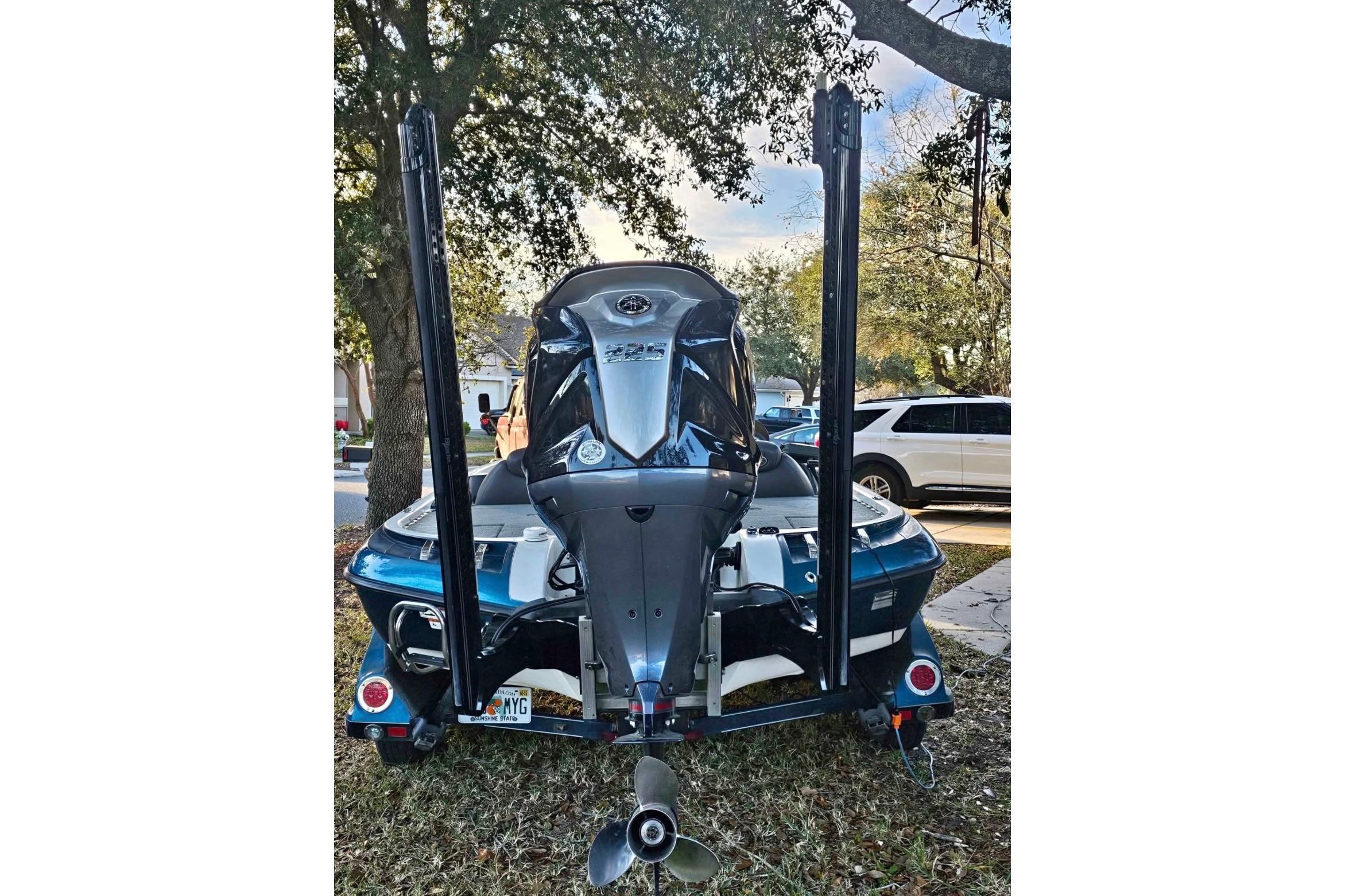 2008 Ranger Z520 Comanche boat with motor, parked outdoors near trees.